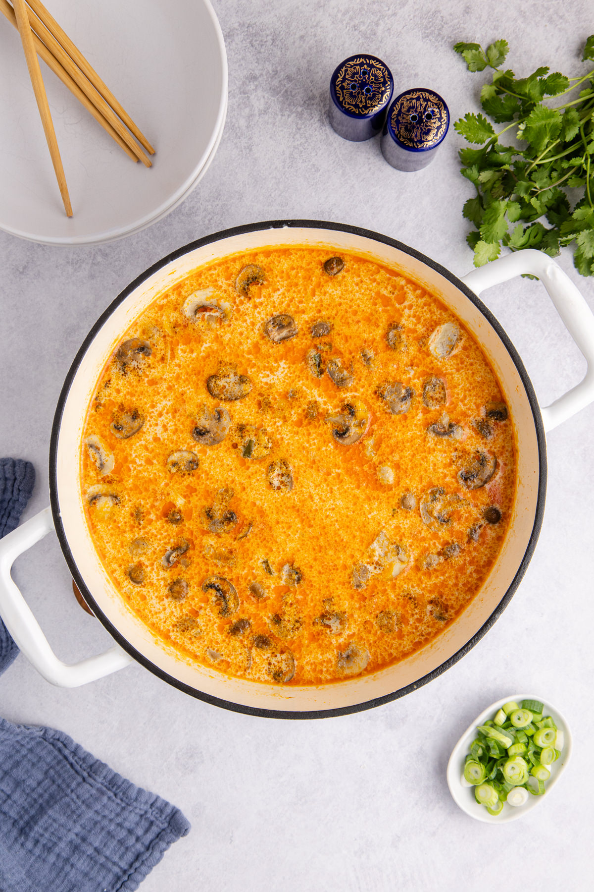 The soup simmering until chicken is cooked.