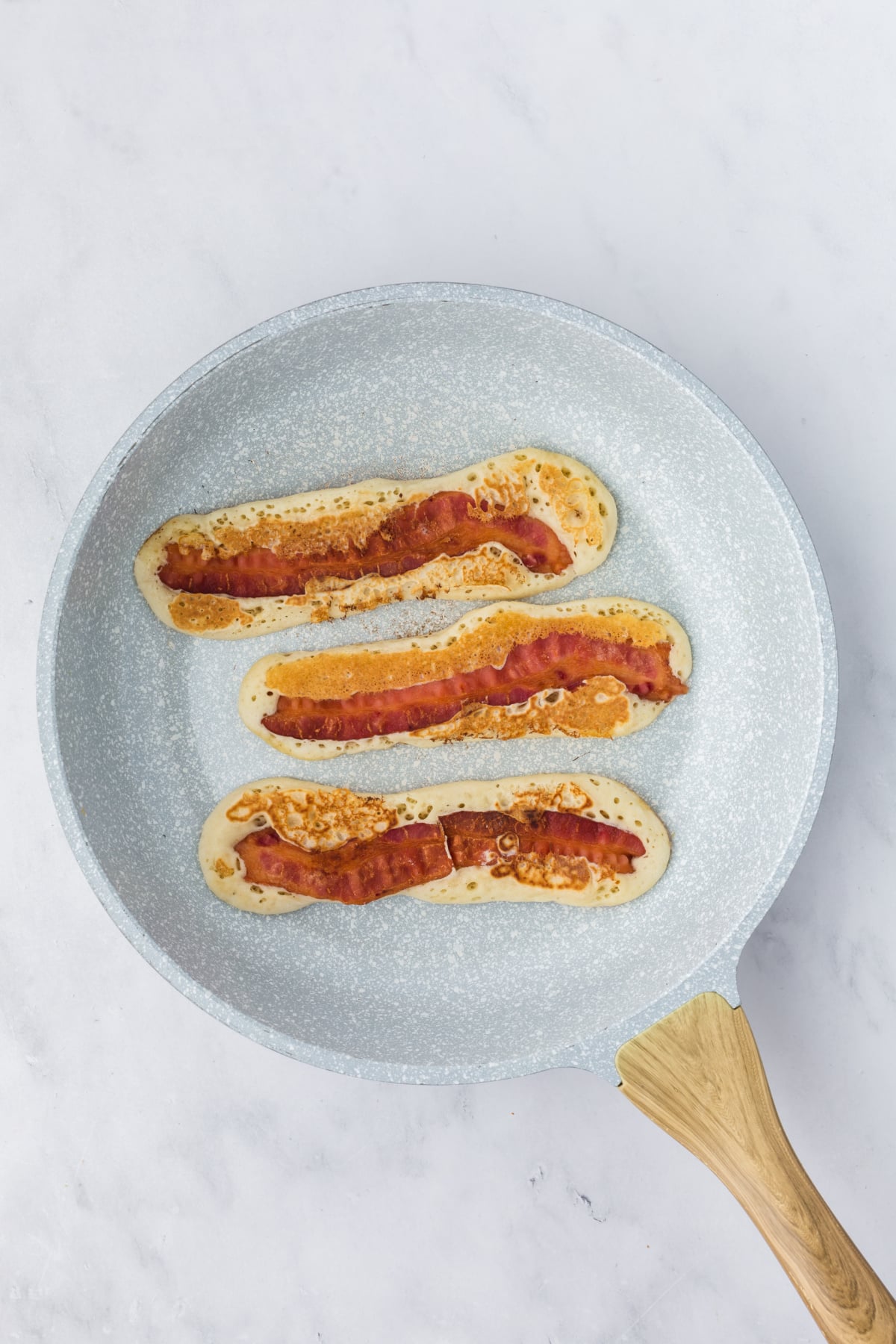 Pancakes flipped to cook on the other side.