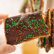 A piece of Easy Christmas Crack Recipe held in the air.