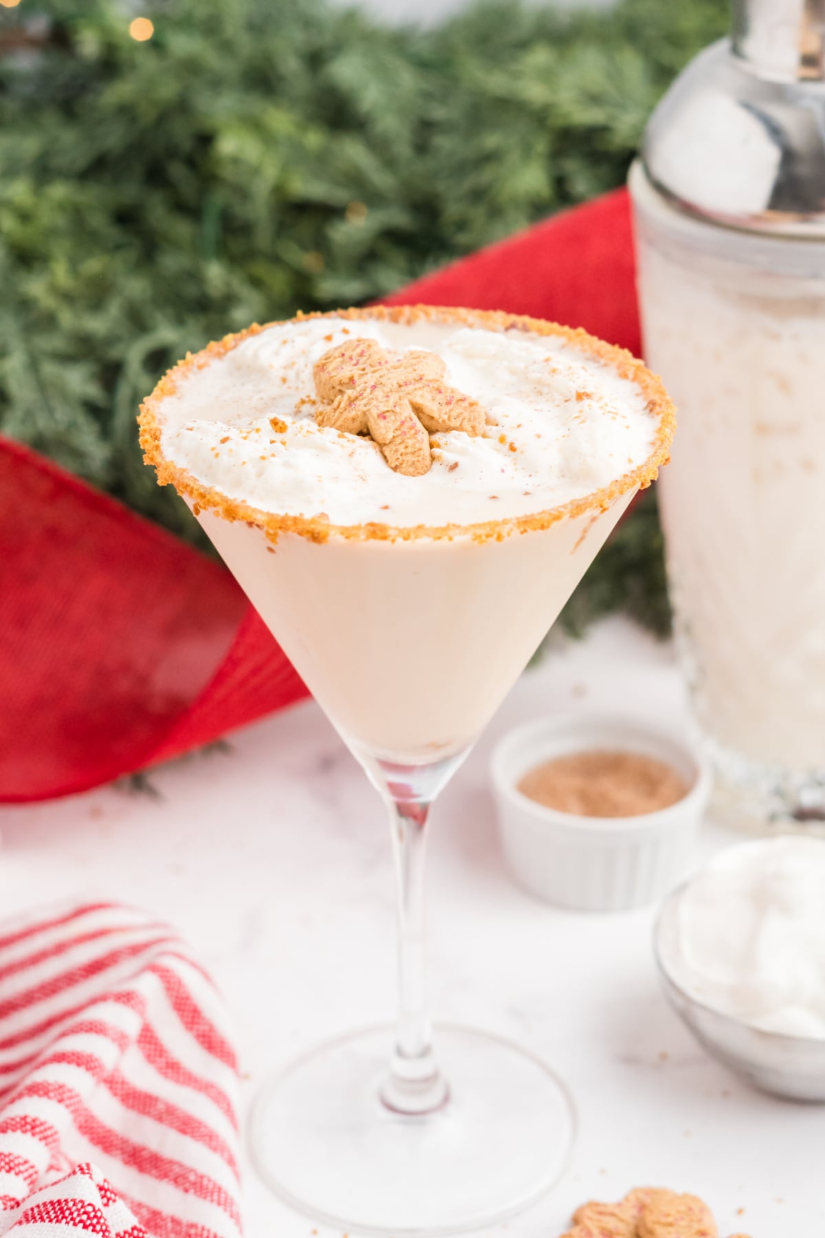 A martini with gingerbread flavoring with a cookie on top.