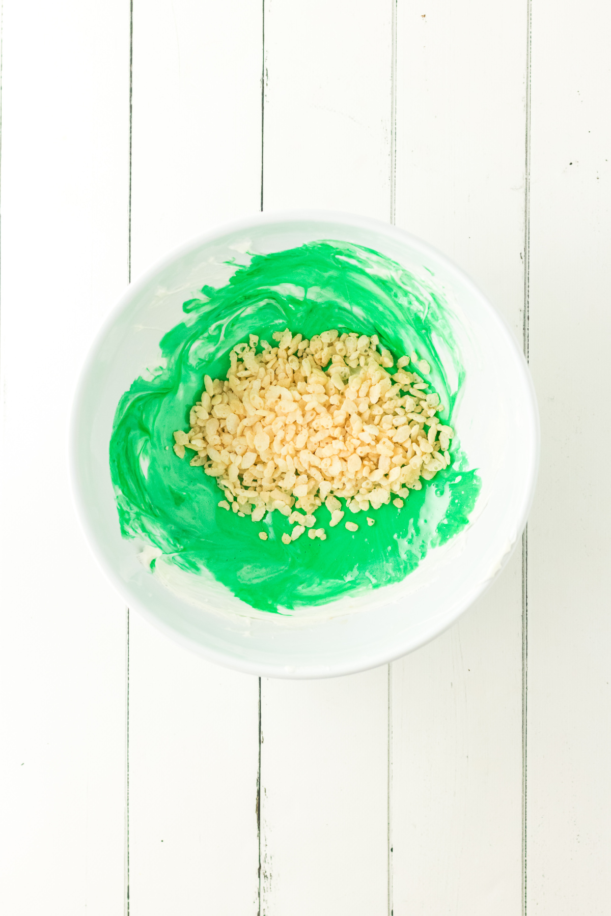 Cereal added to the colored mixture.