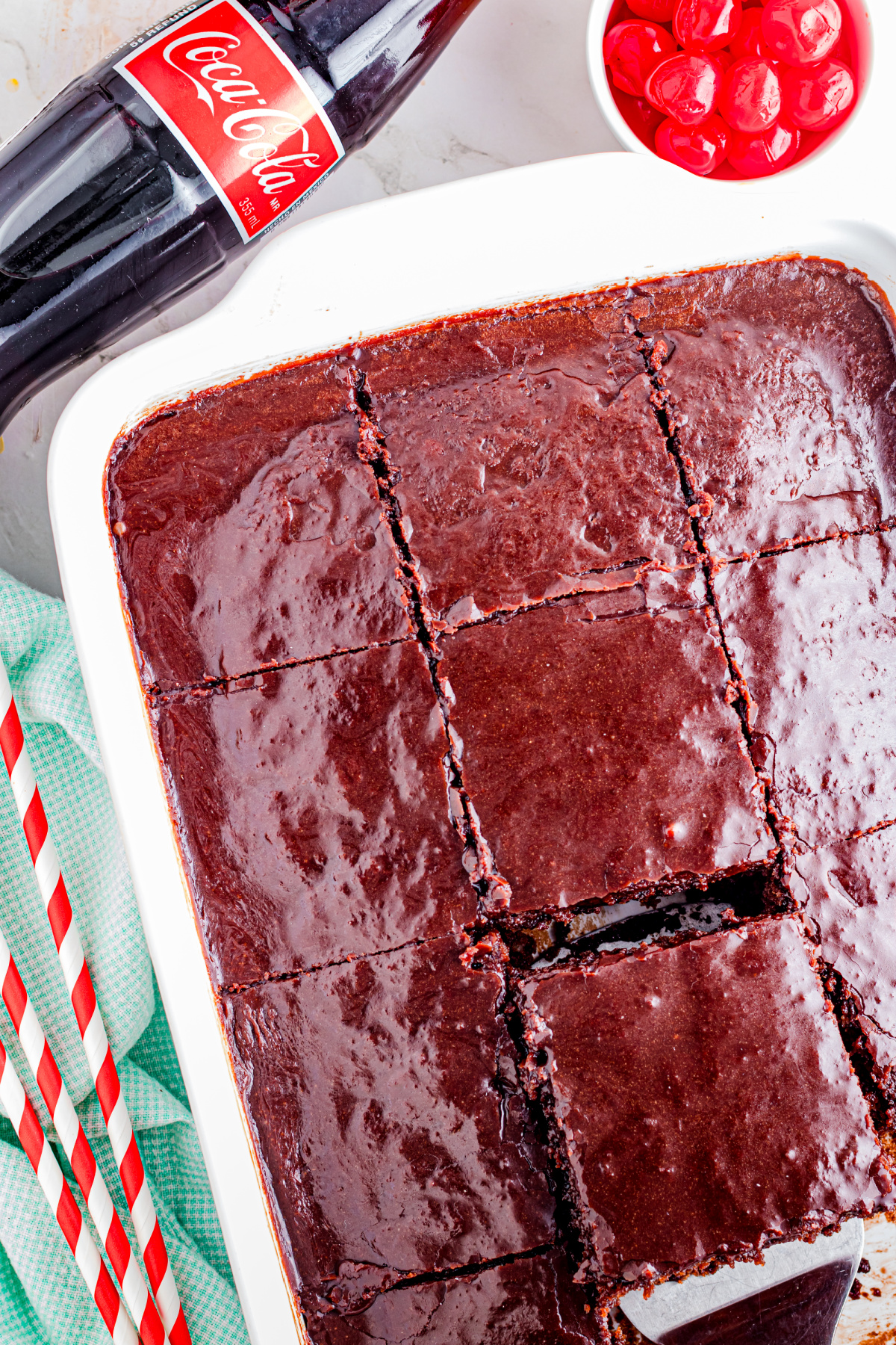 Cake with coca cola cut up in a baking dish.