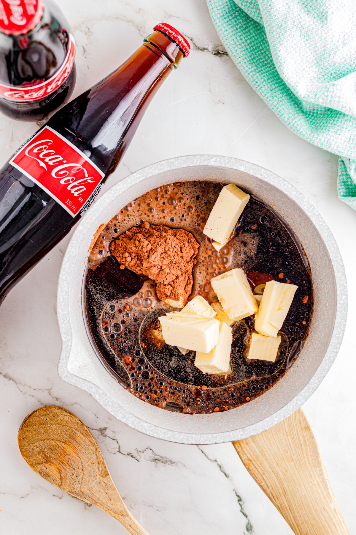 Soda, butter, oil, and cocoa combined in a saucepan.