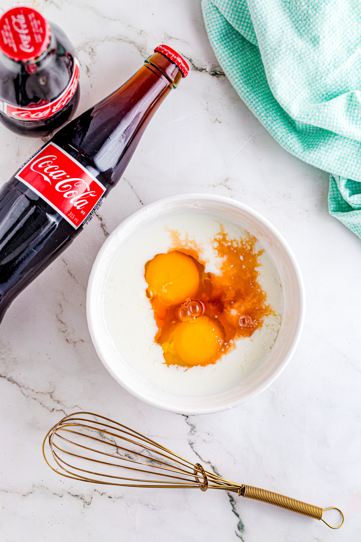 Eggs, buttermilk, and vanilla mixed in a smaller bowl.