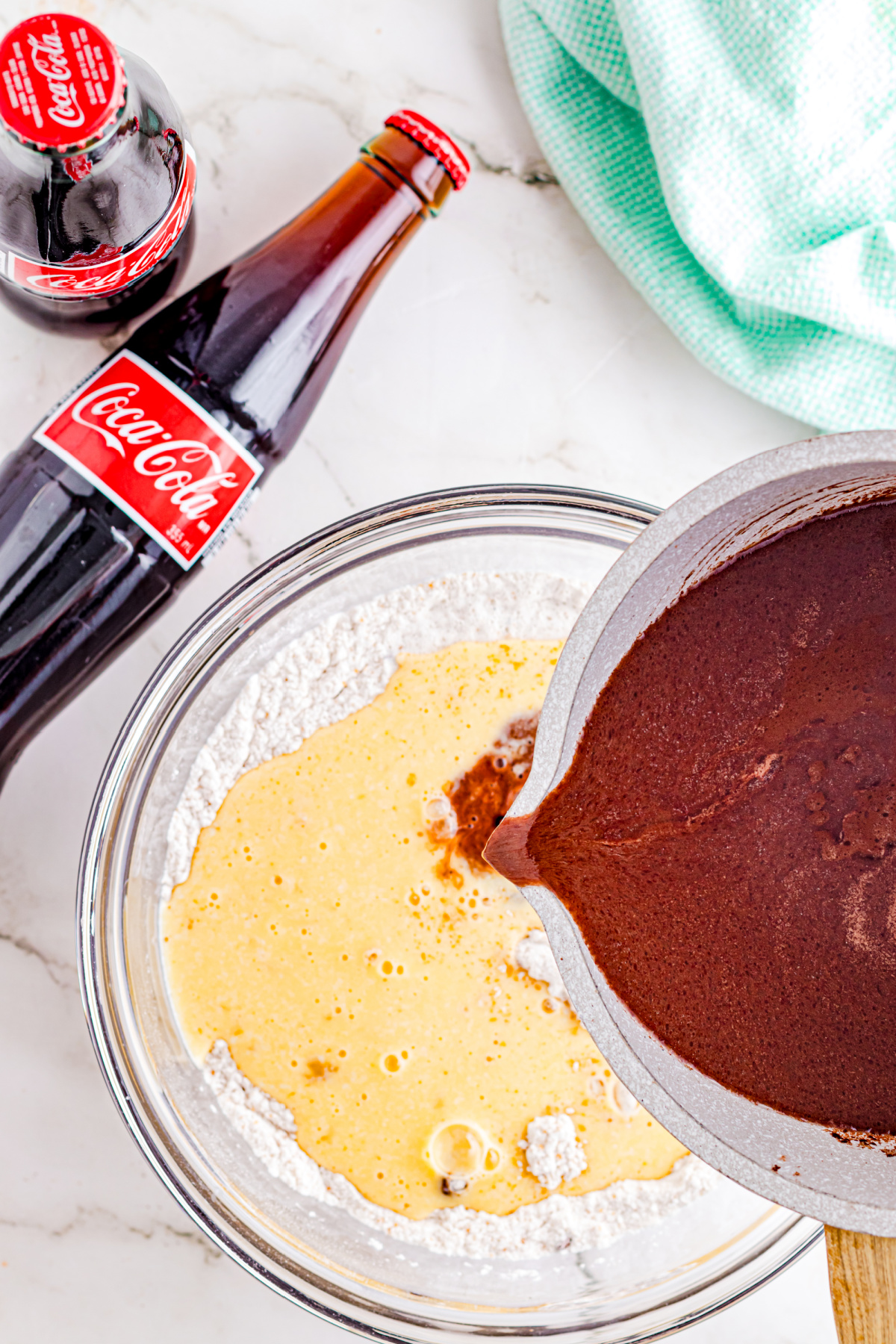 Cooled coke mixture and egg mixture combined in the bowl with the dry ingredients.