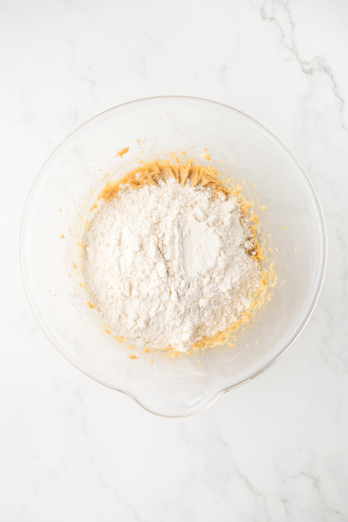 The dry ingredients added to the wet ingredients in a bowl.