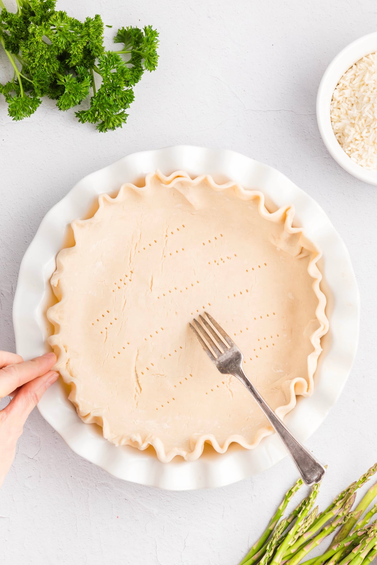 Holes being poked in the pie crust.