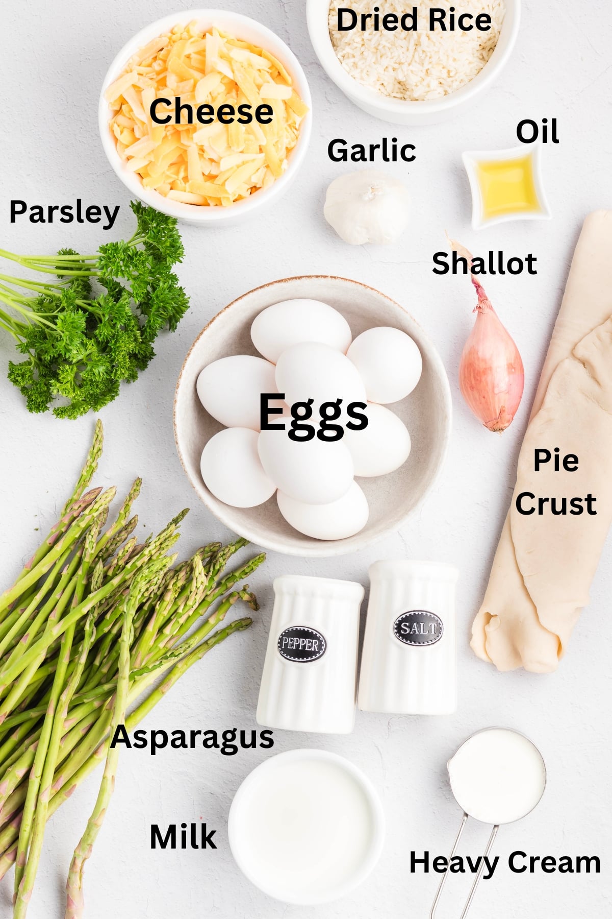Ingredients to make an asparagis quiche on a table.