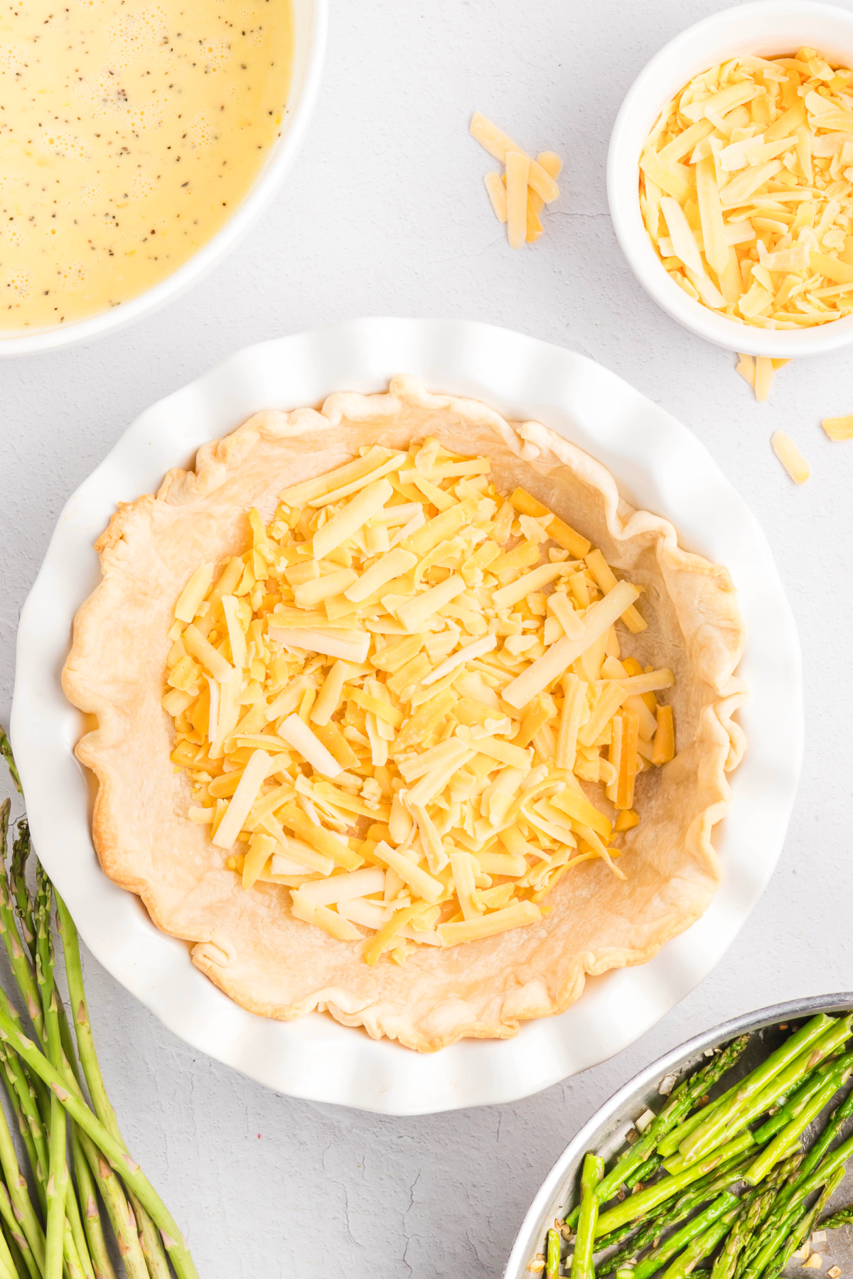 A cup of shredded cheese added to the bottom of the crust.