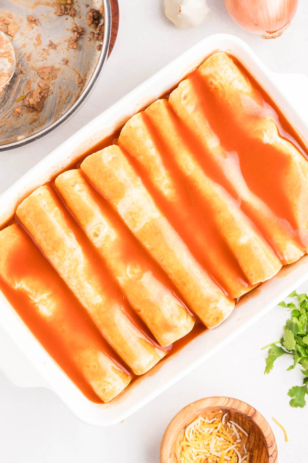 Enchilada sauce poured on top of the enchilada.