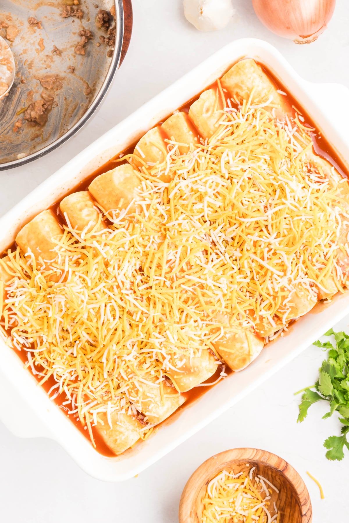 Shredded cheese over top of the enchiladas.