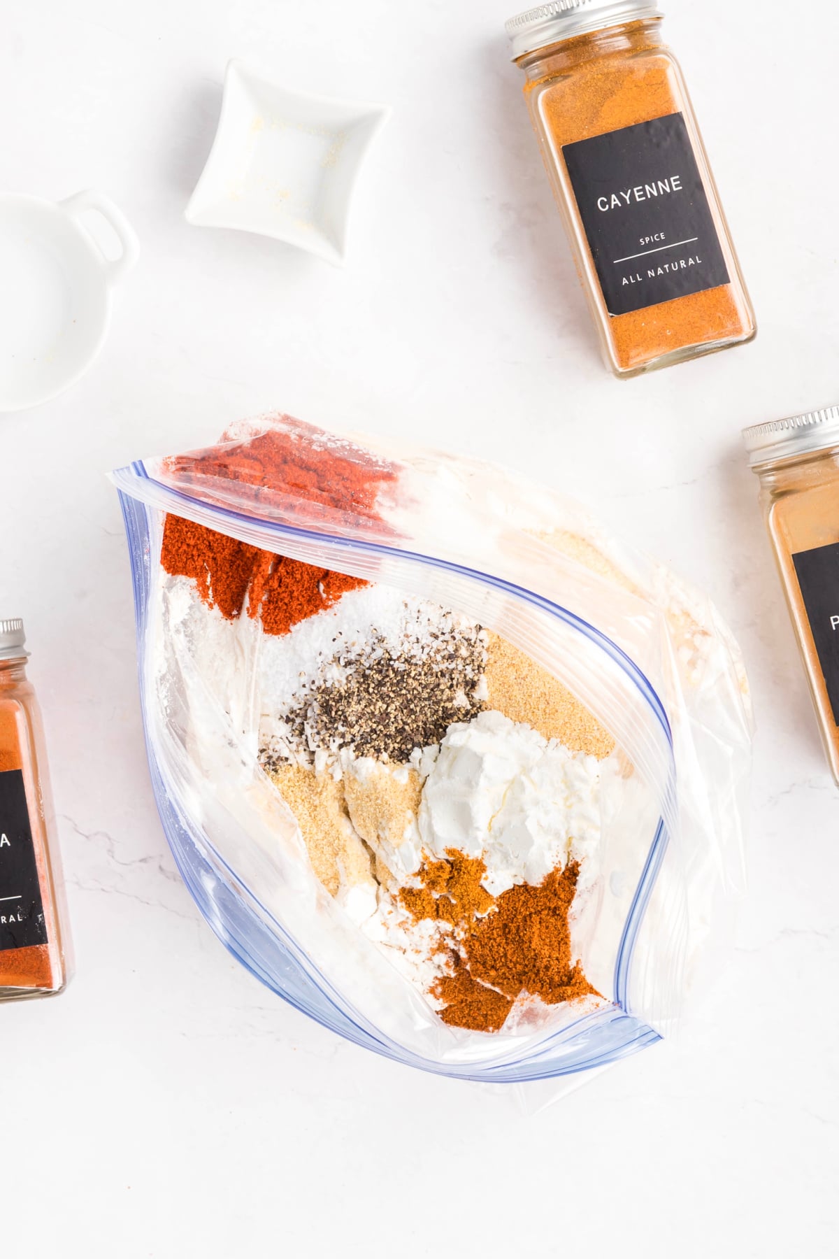 Flour, cornstarch, and spices in a Ziploc bag.