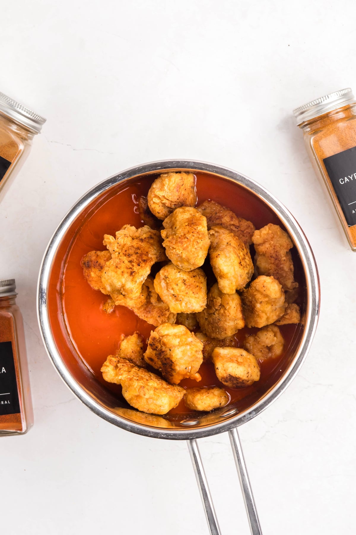 The chicken added to the buffalo sauce.