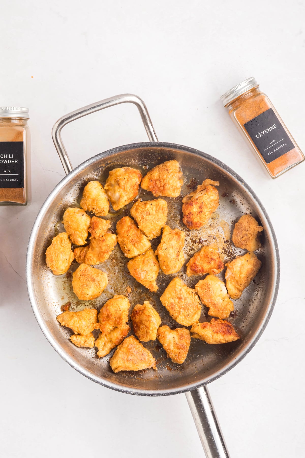 Chicken cooking in a skillet.