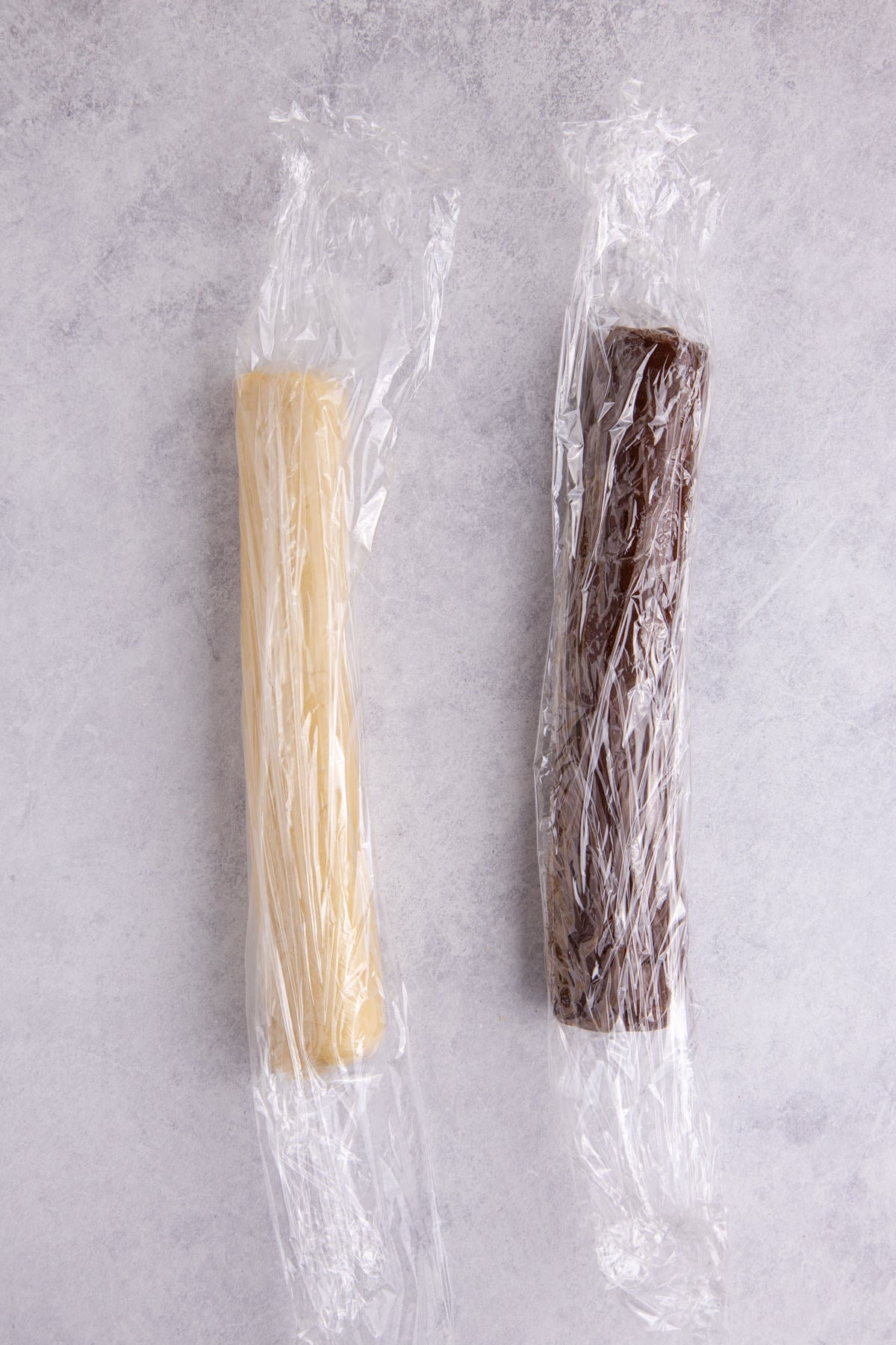 Dough rolled into two different colored logs.