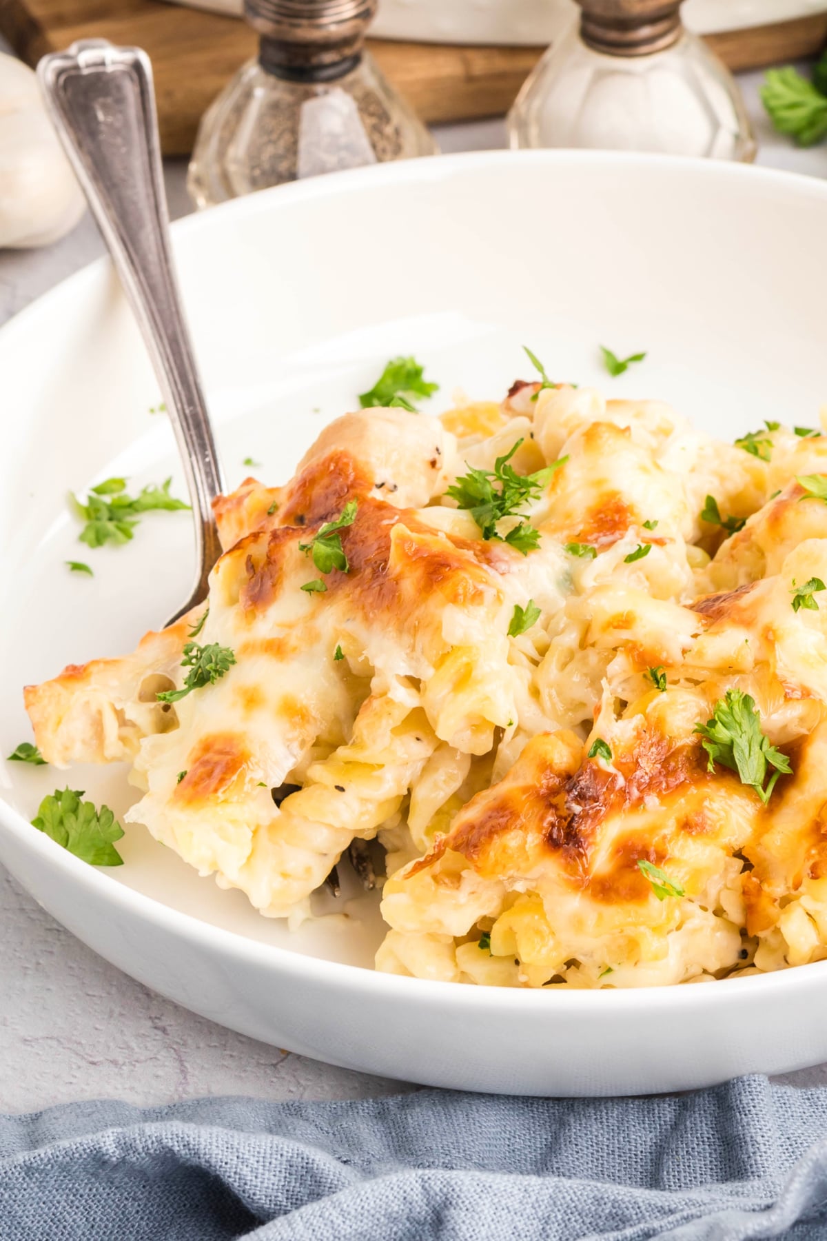 A spoon scooping out some chicken alfredo.