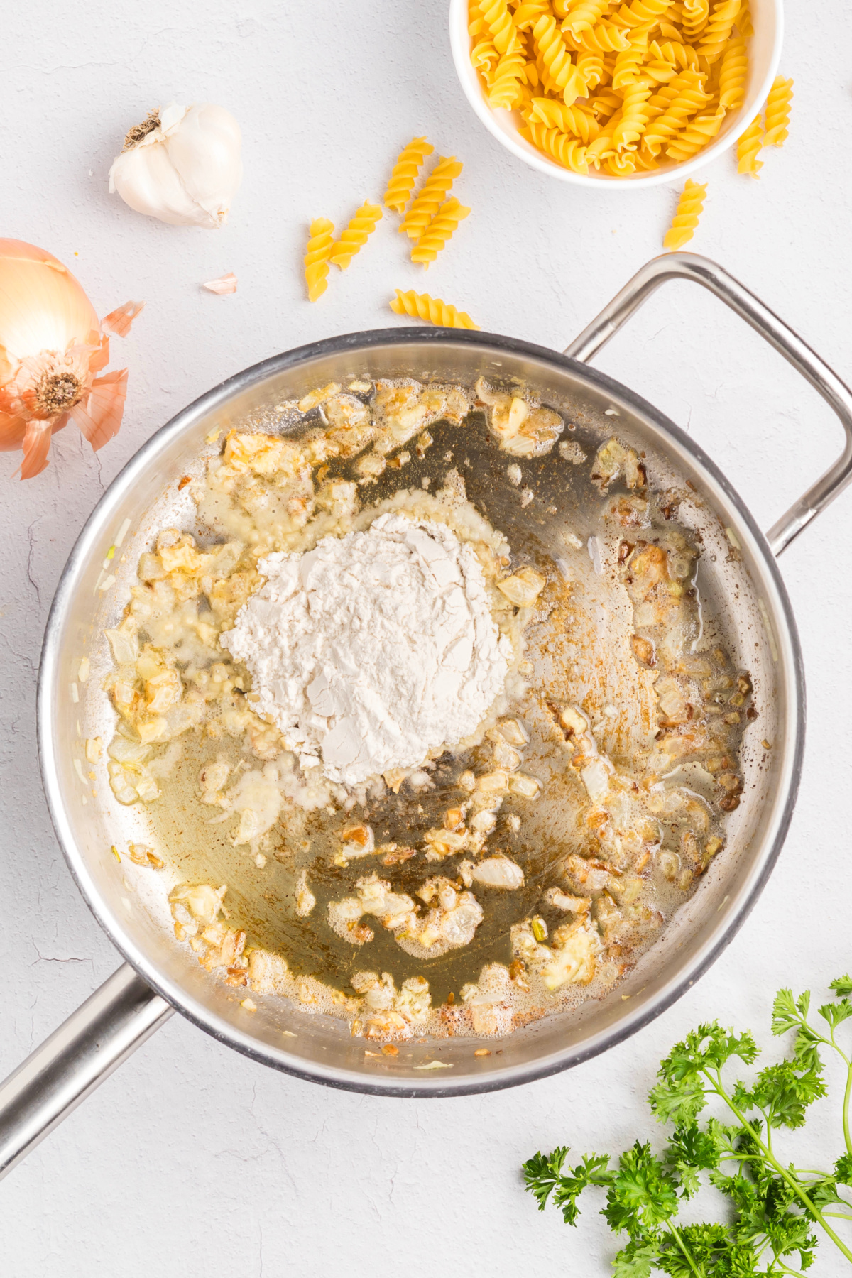 Butter, garlic and onions sauteed in a pan.