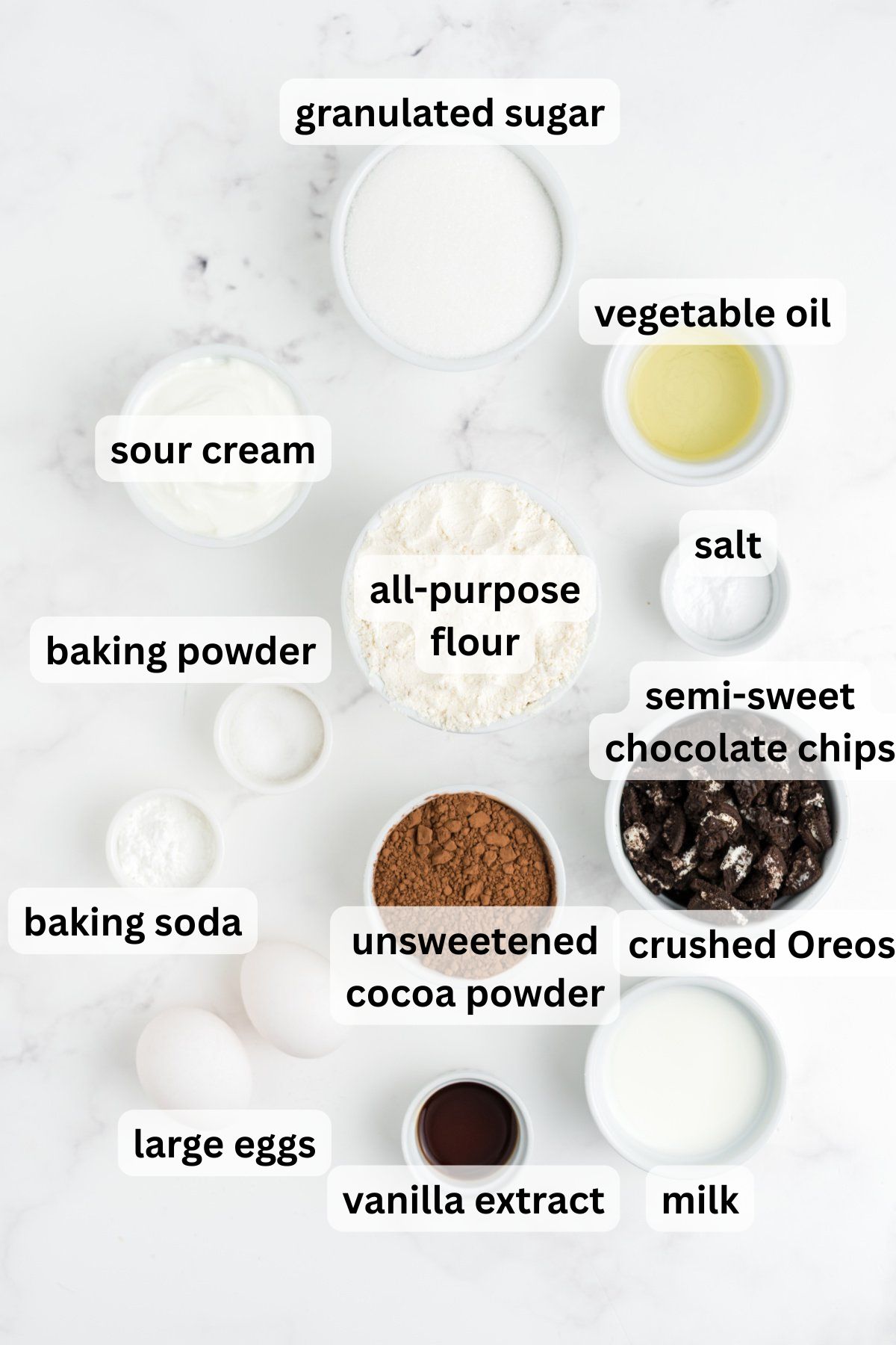 Ingredients to make these muffins in bowls on a table.
