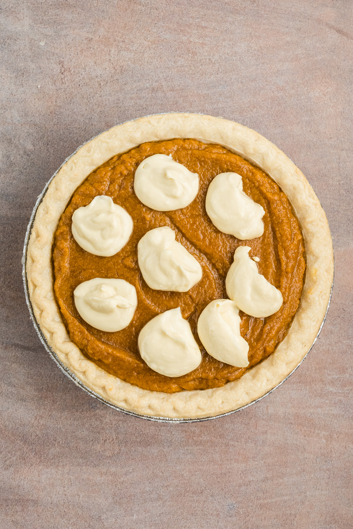 The pumpkin filling poured into the pie.