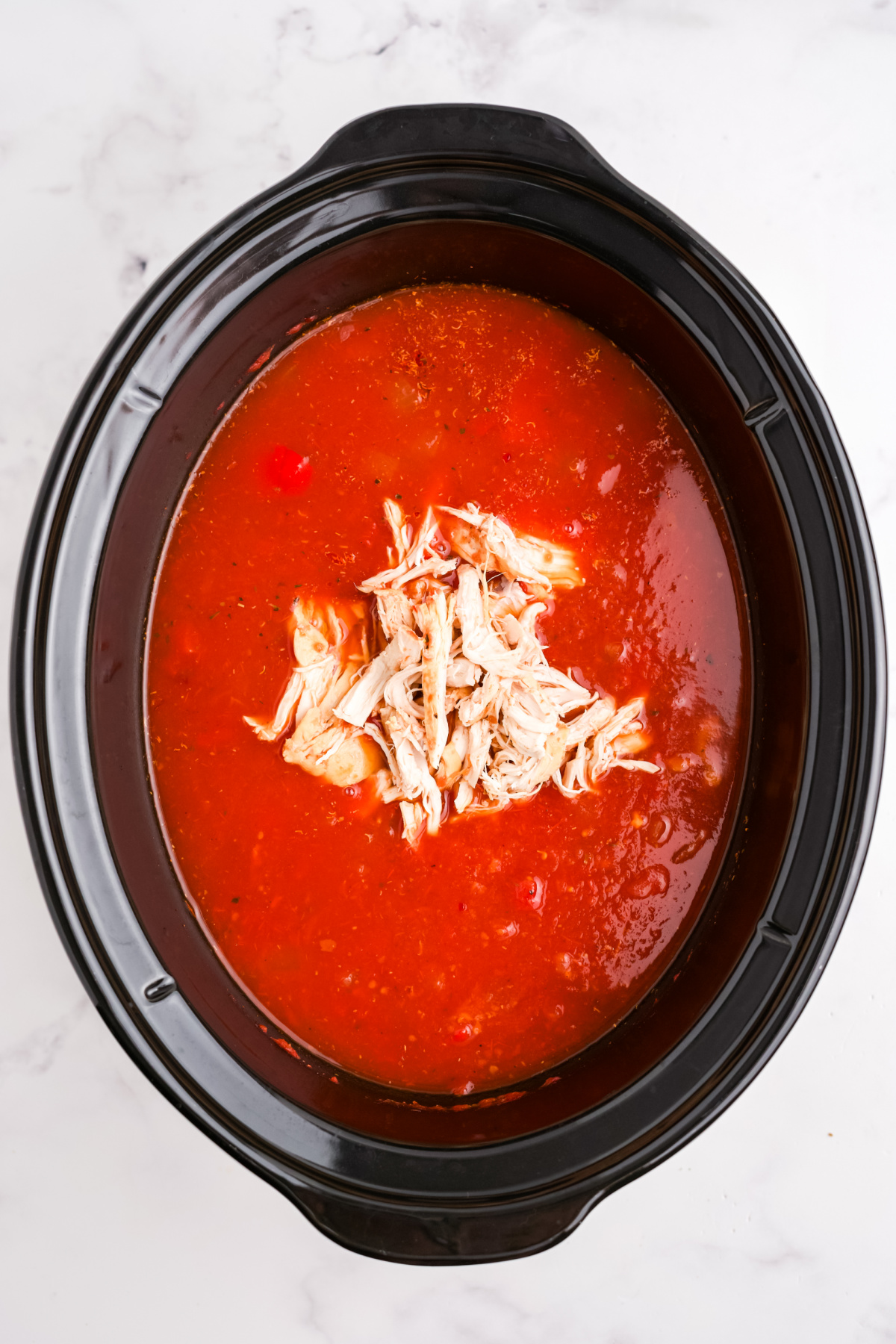 The chicken added back into the soup.