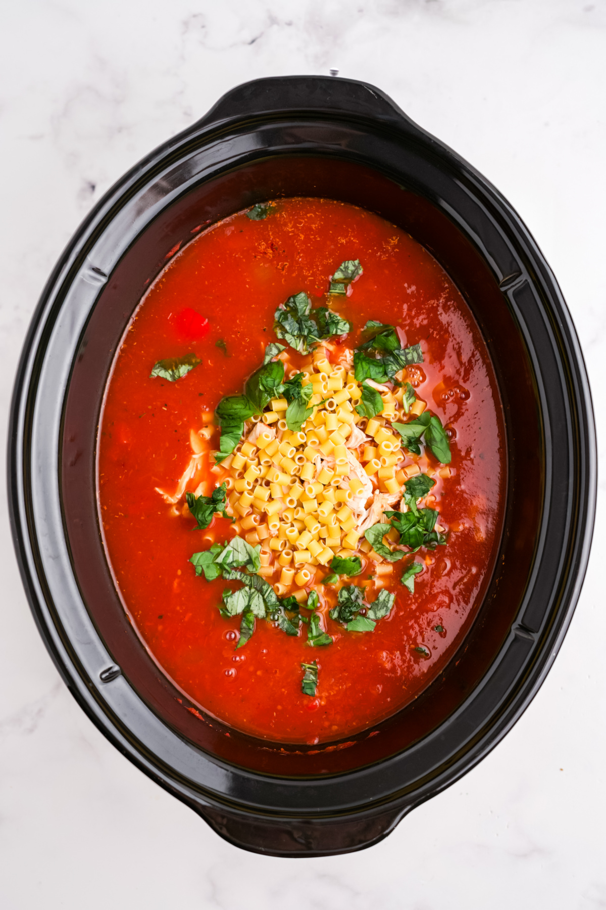 Shredded basil added to the soup.