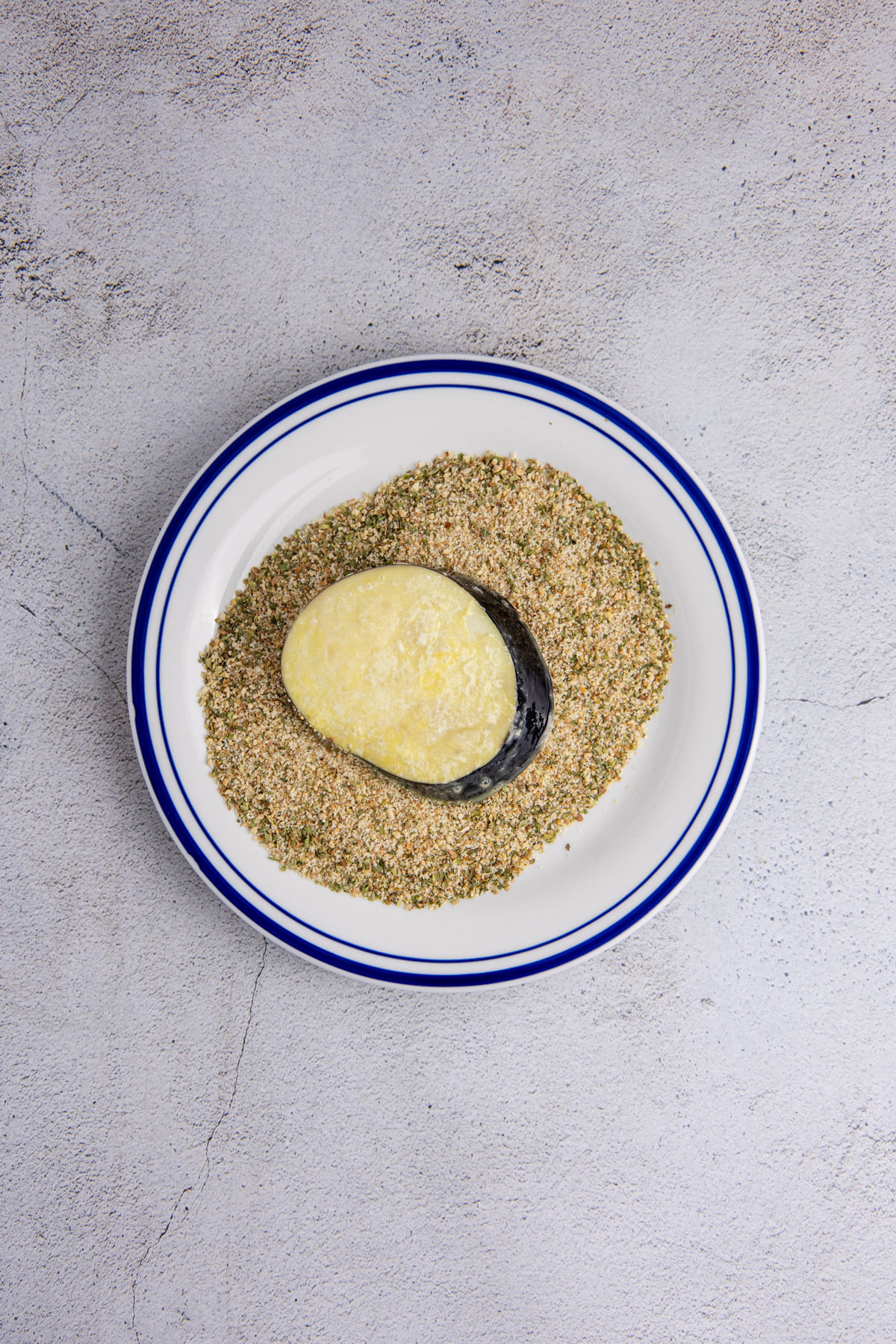 Eggplant dipped into the breadcrumbs.