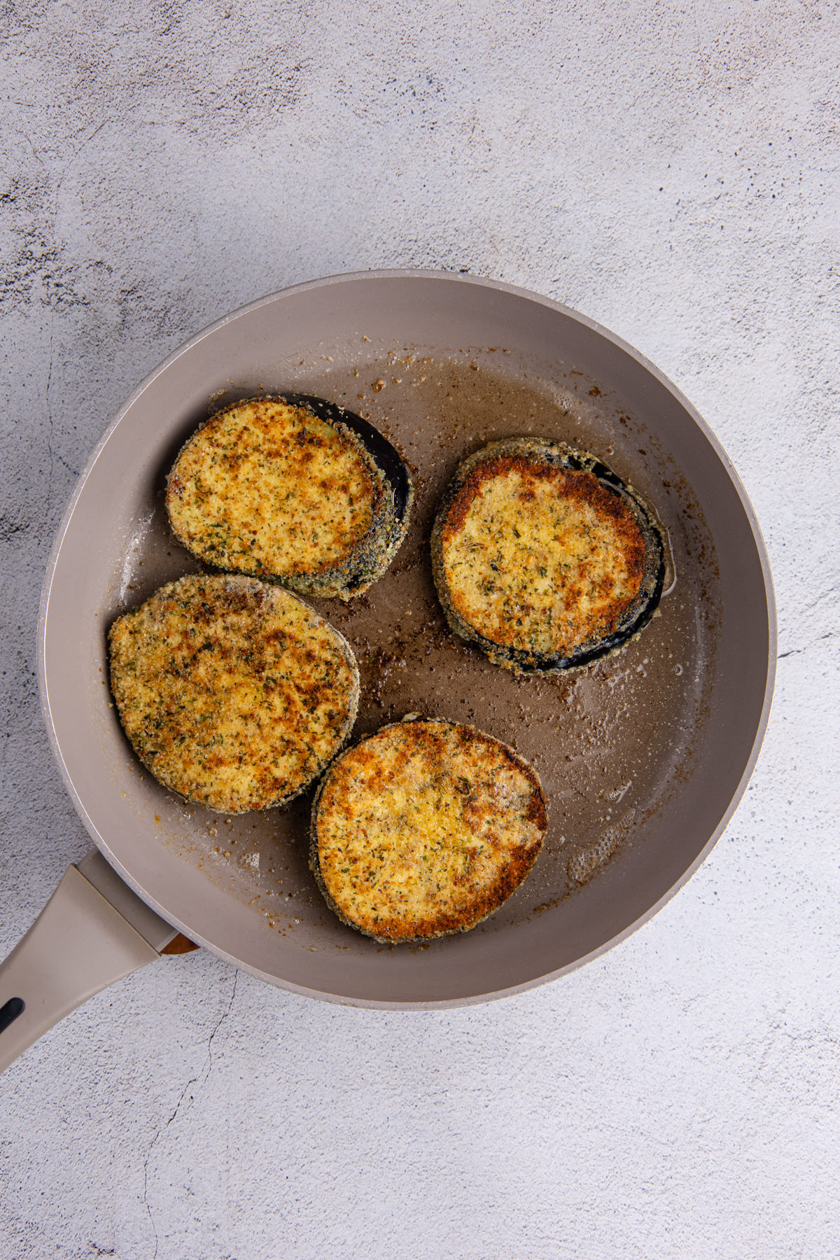 Eggplant fried in a pan.