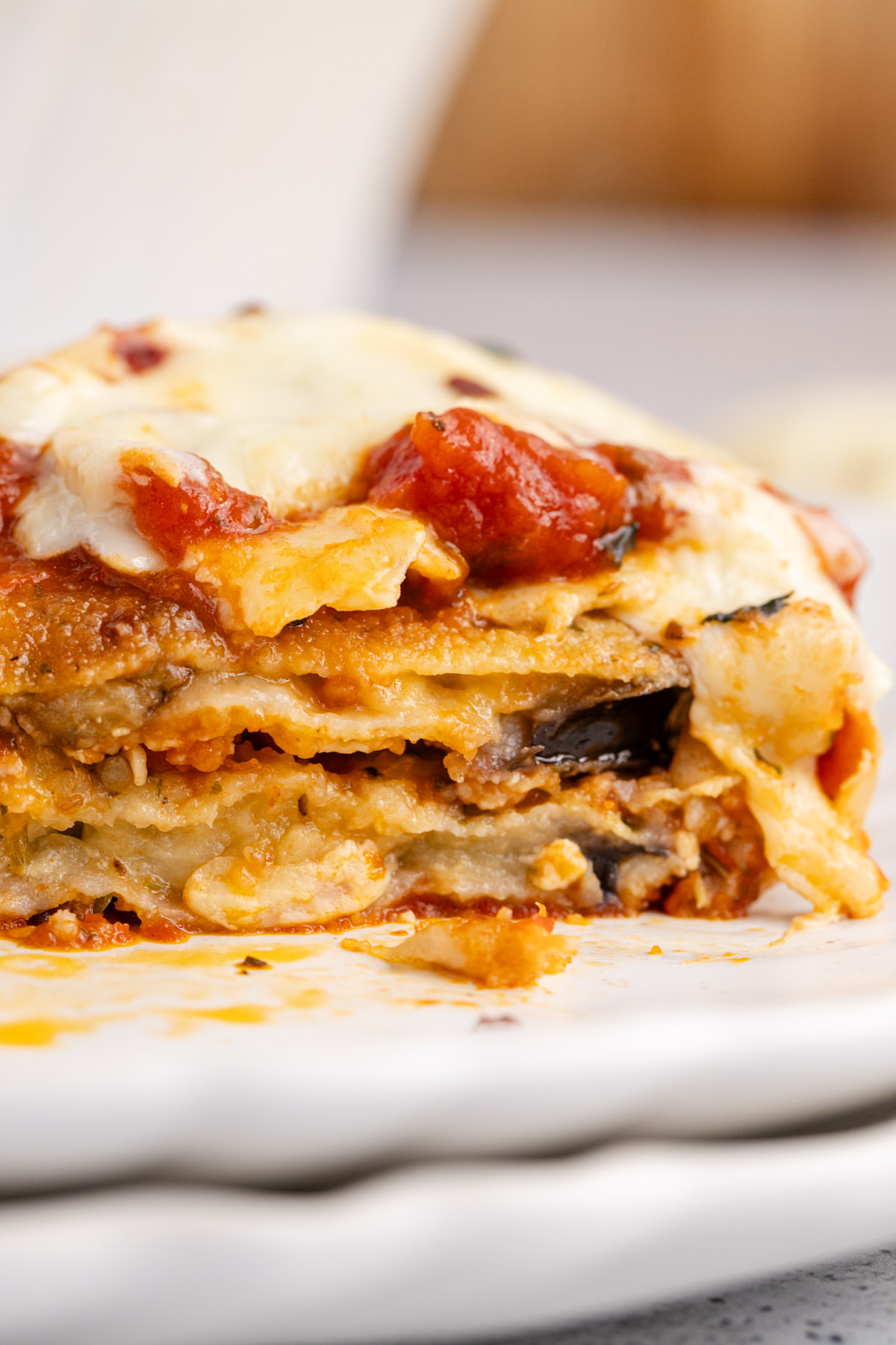 Casserole with eggplant, sauce and cheese on a plate.