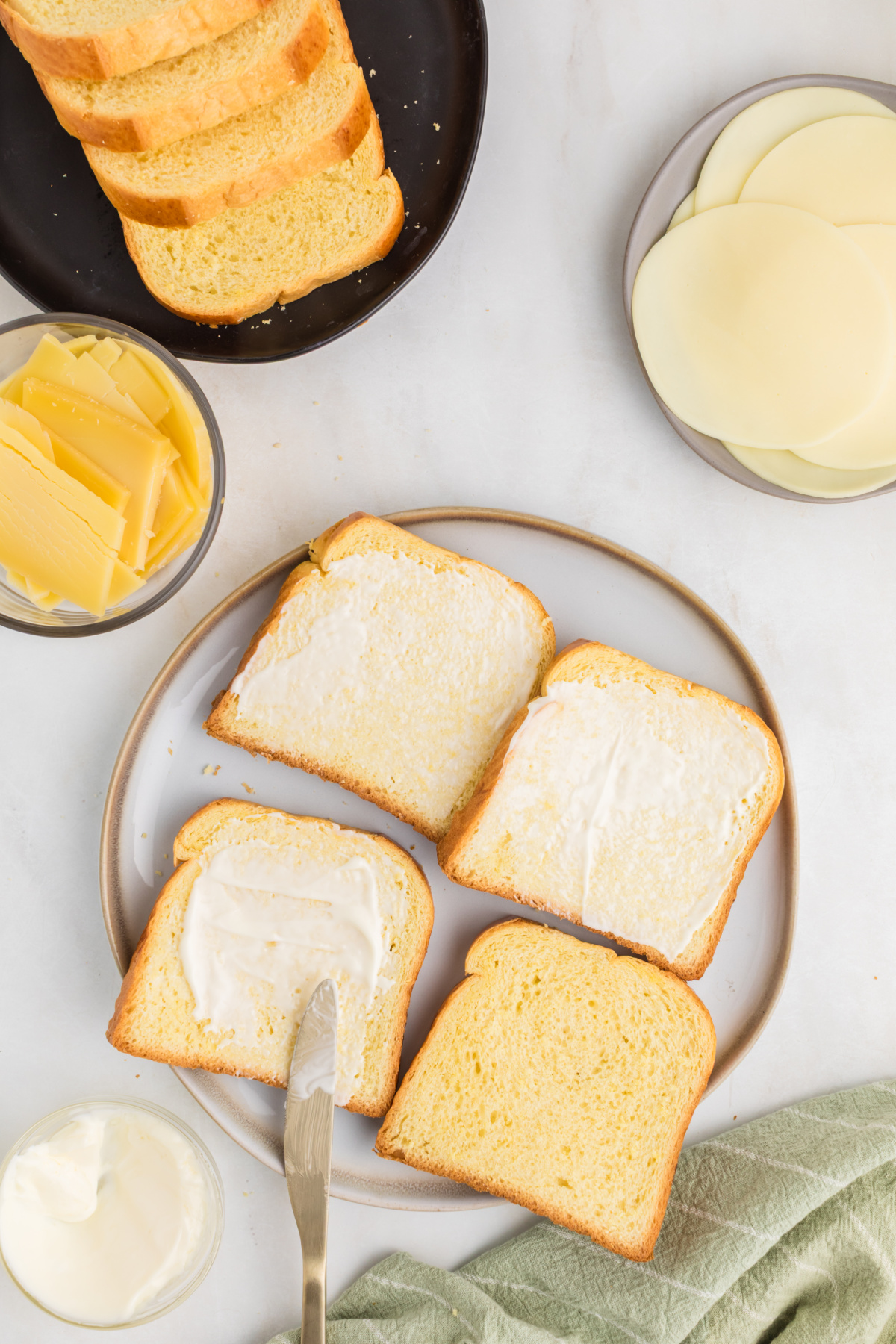 Mayo added on both sides on each slice of bread.
