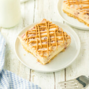 A peanut butter and jelly cheesecake bar on a plate.