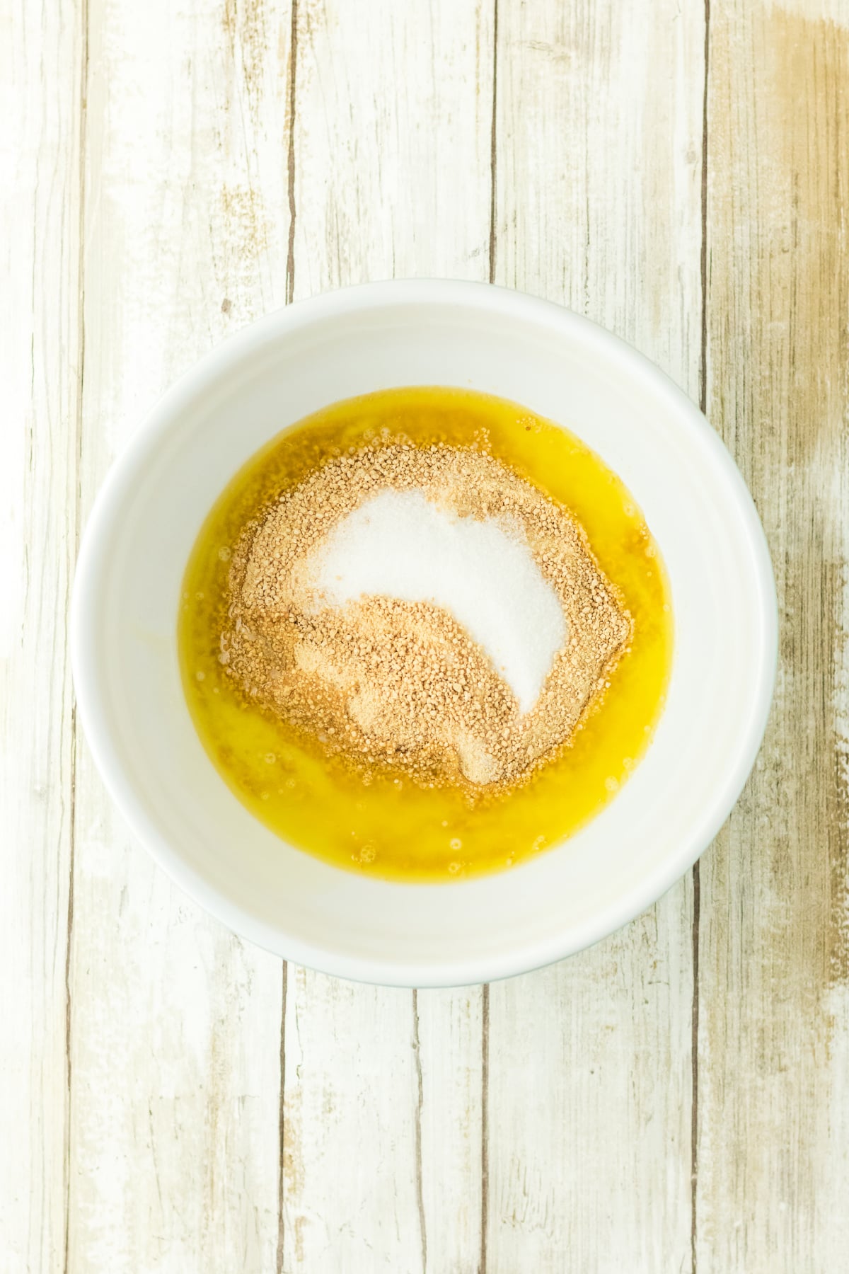 Graham cracker and melted butter in a bowl.