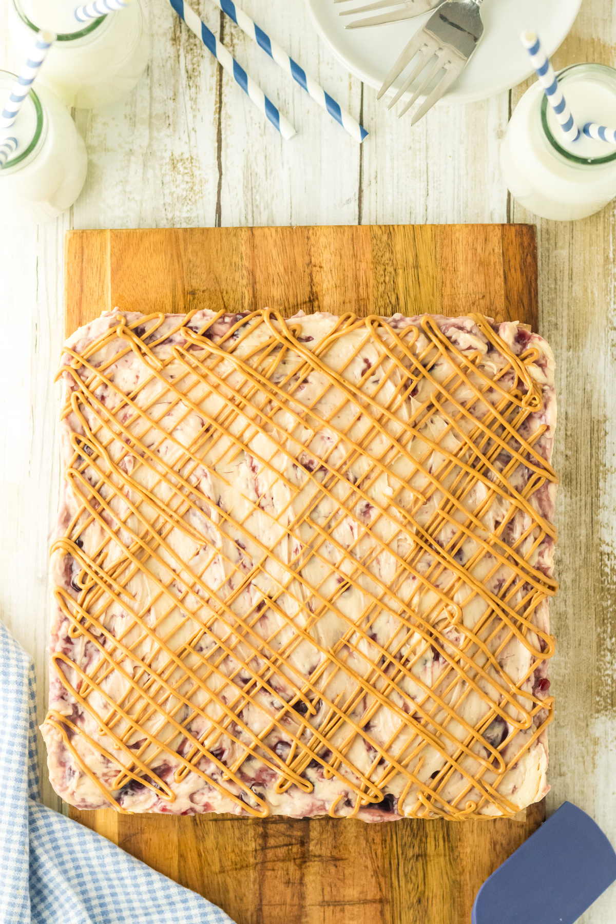 Peanut butter drizzled over top of the cheesecake.