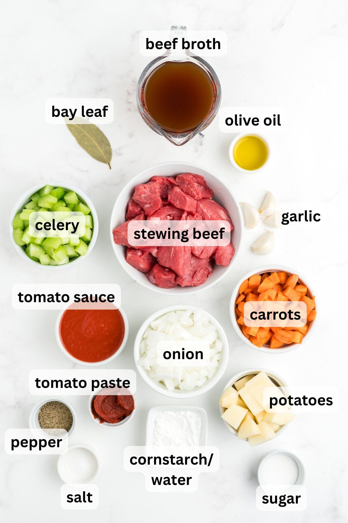 Ingredients to make this Hawaiian stew in bowls on a table.