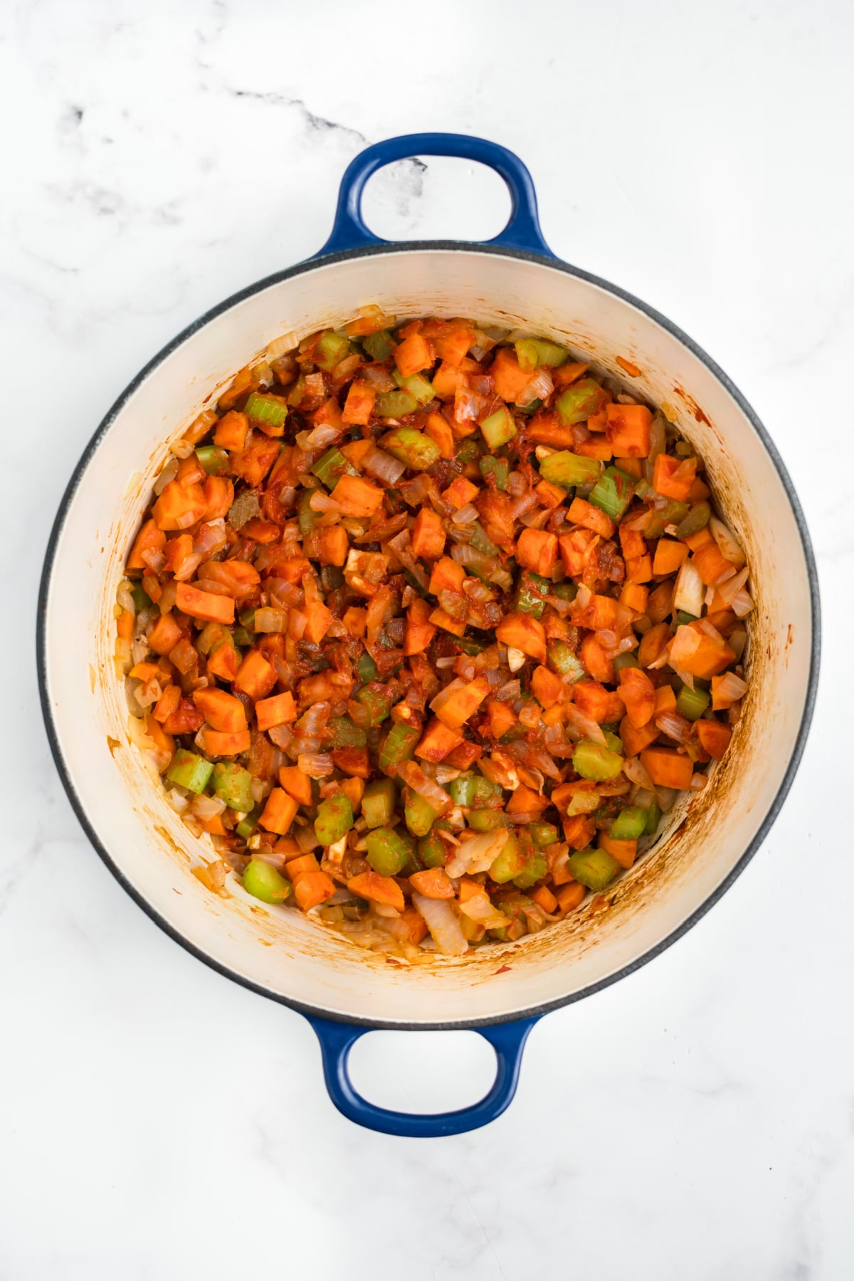 Onions, celery, carrots and tomato paste added to the pot