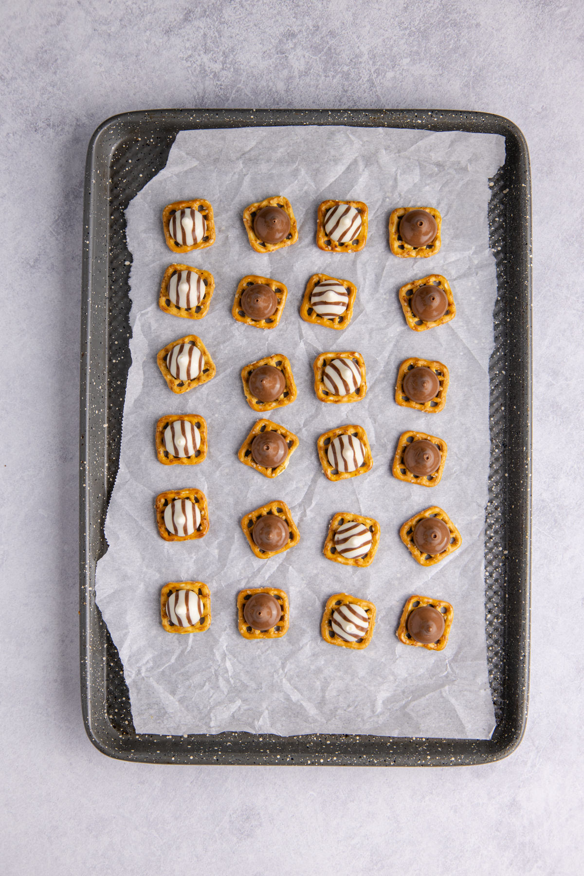 Pretzel snaps arranged on the prepared baking sheet.