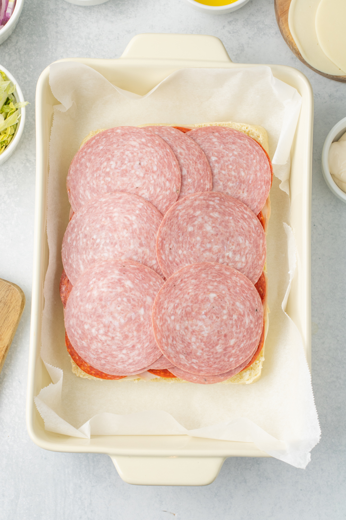 Cheese, ham, pepperoni, and salami on rolls.