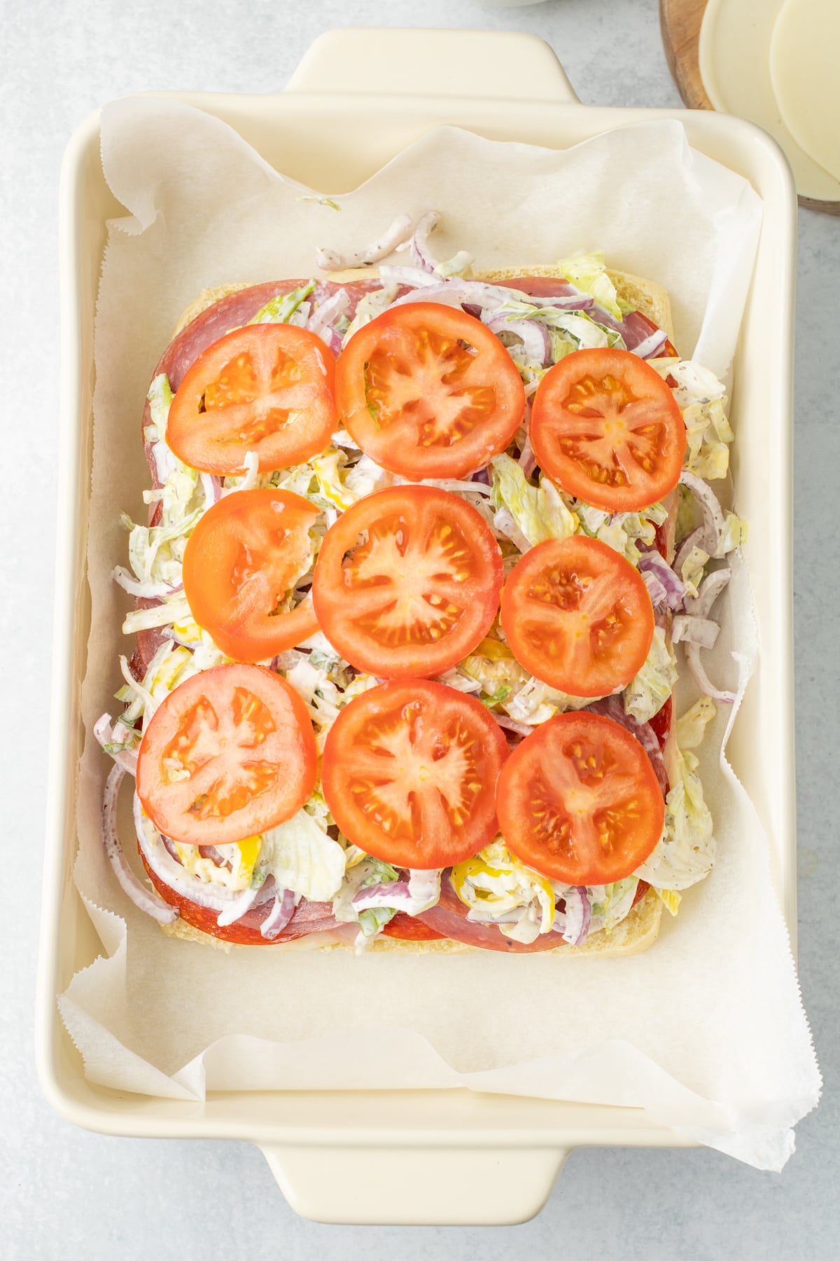 Lettuce mixture, tomato slices, and remaining cheese set onto the sliders.