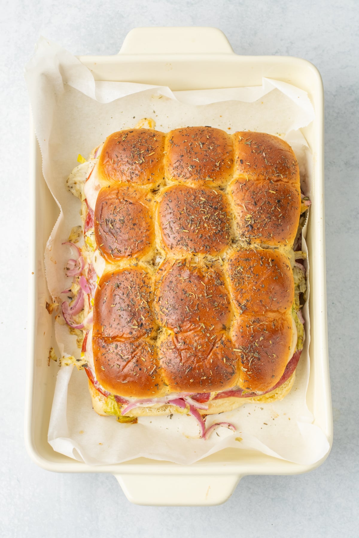 Melted butter and Italian seasoning brushed on top of the rolls.