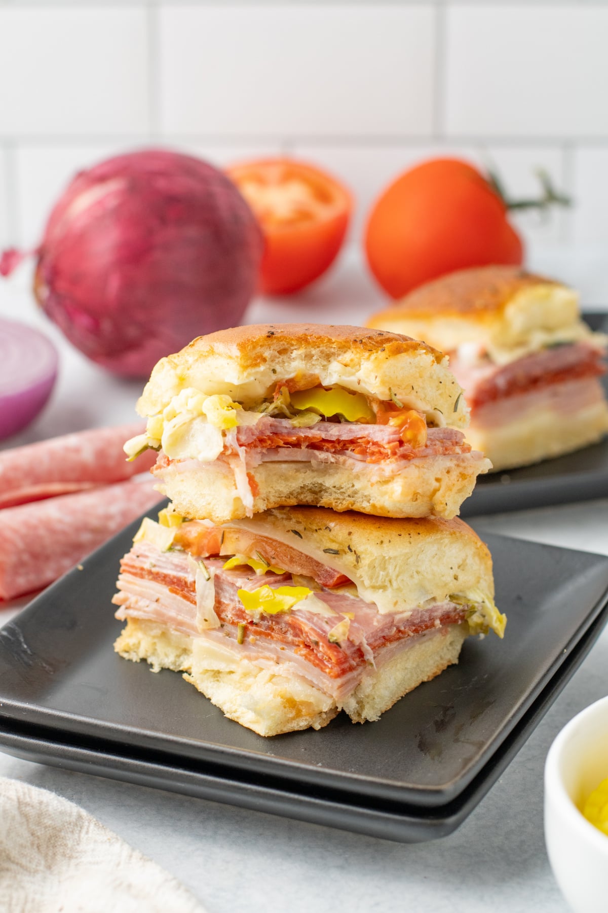 Sliders stacked on top of each other on a plate.