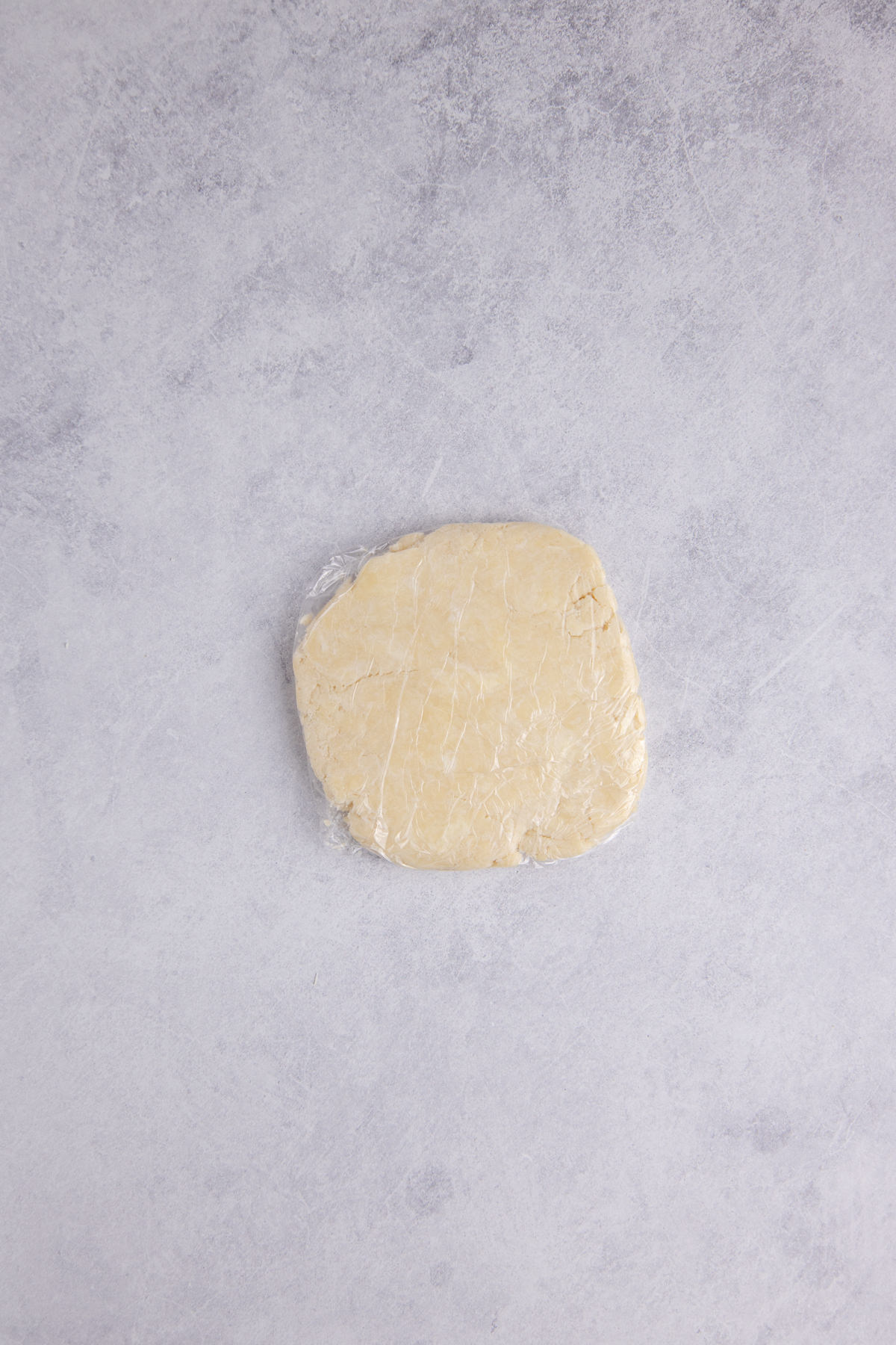 Dough covered with plastic wrap to put in the fridge to chill.