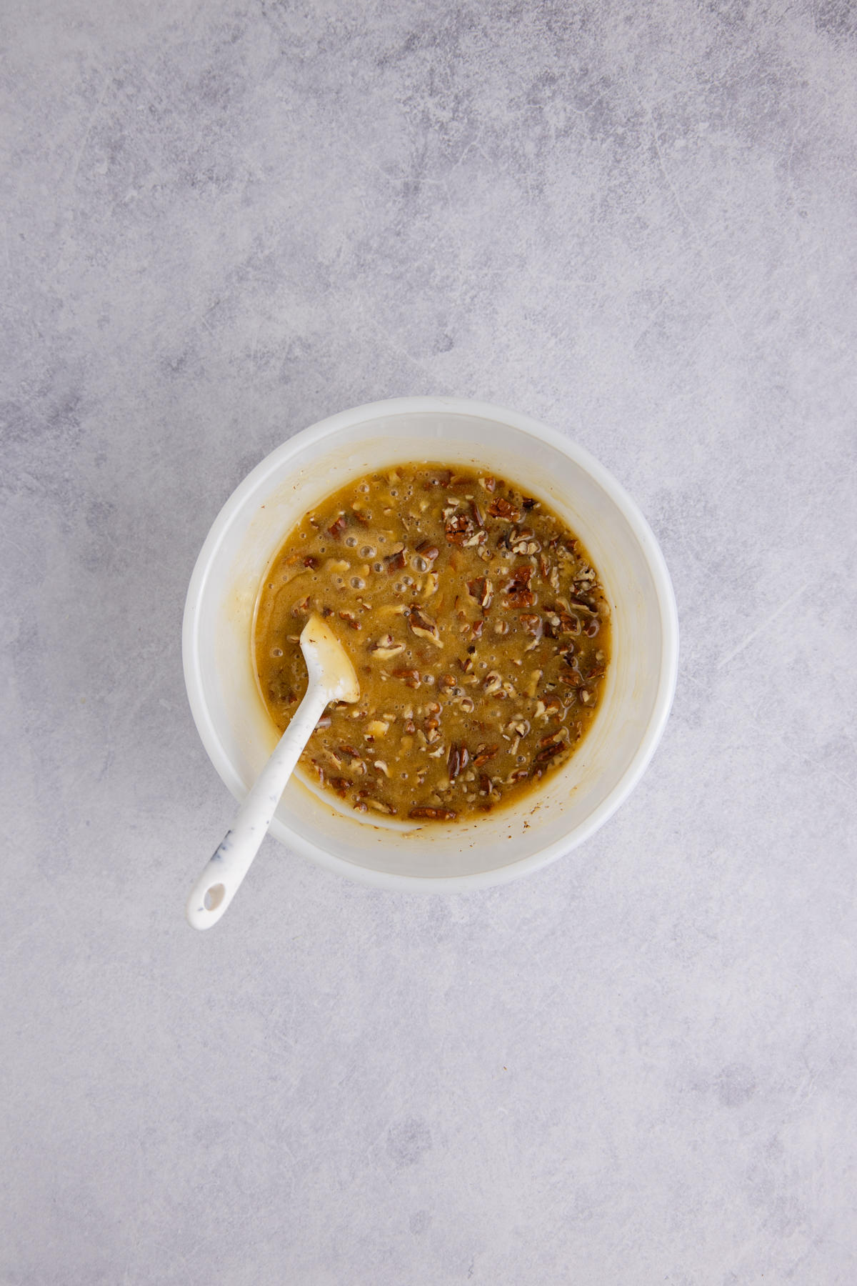 All the ingredients for the pecan filling combined in a mixing bowl.