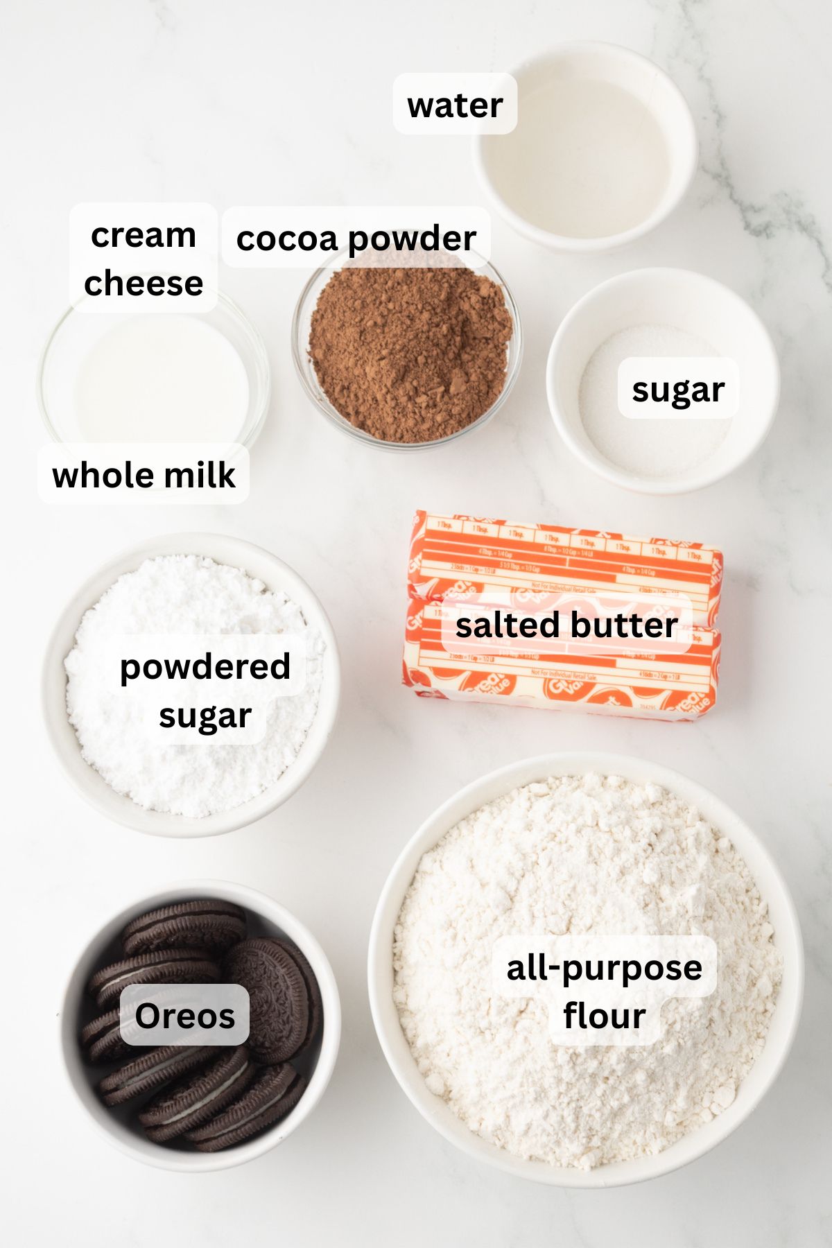 All of the ingredients needed to make Oreo Pop-Tarts in bowls on a counter.