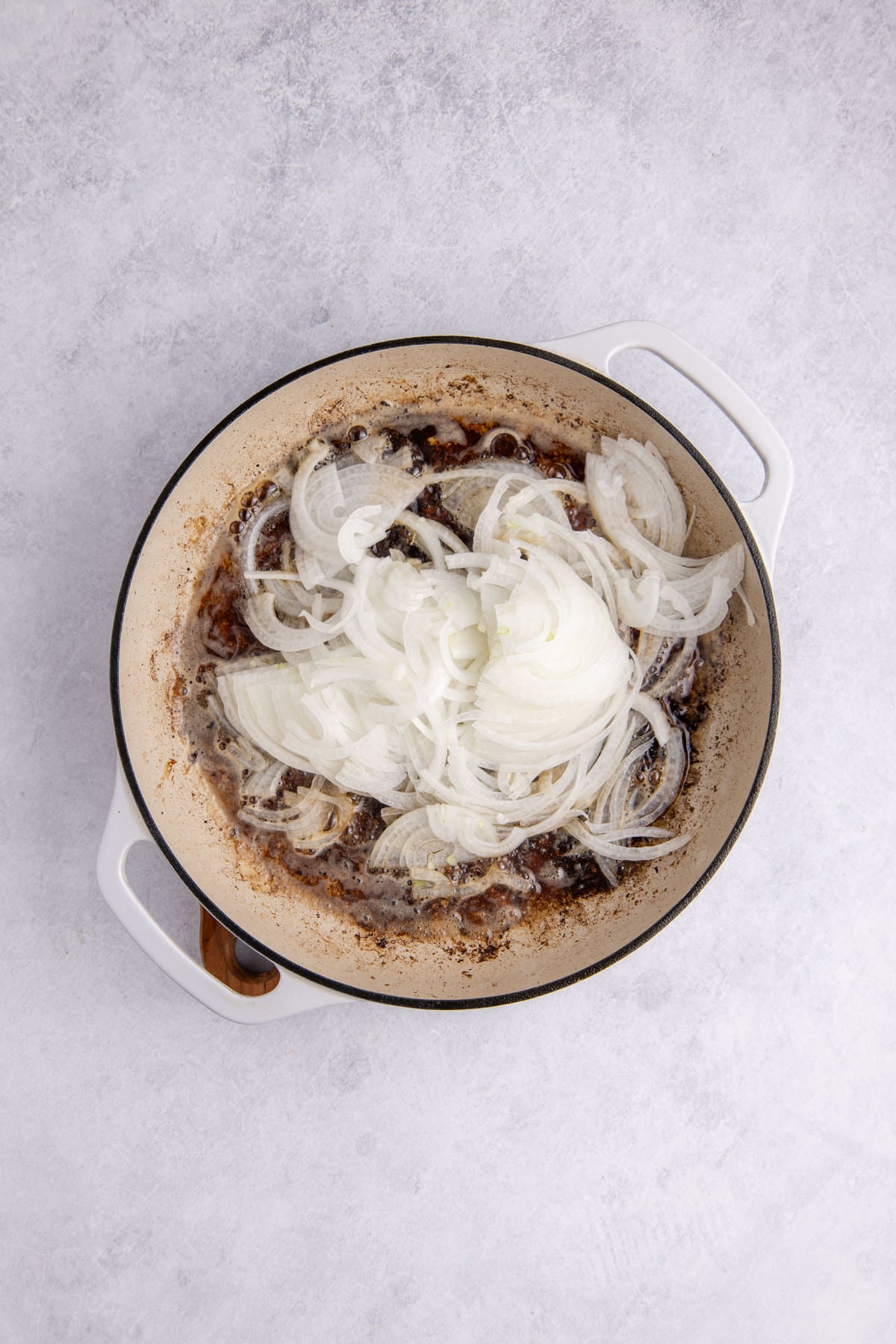 Onions added to the skillet to saute.