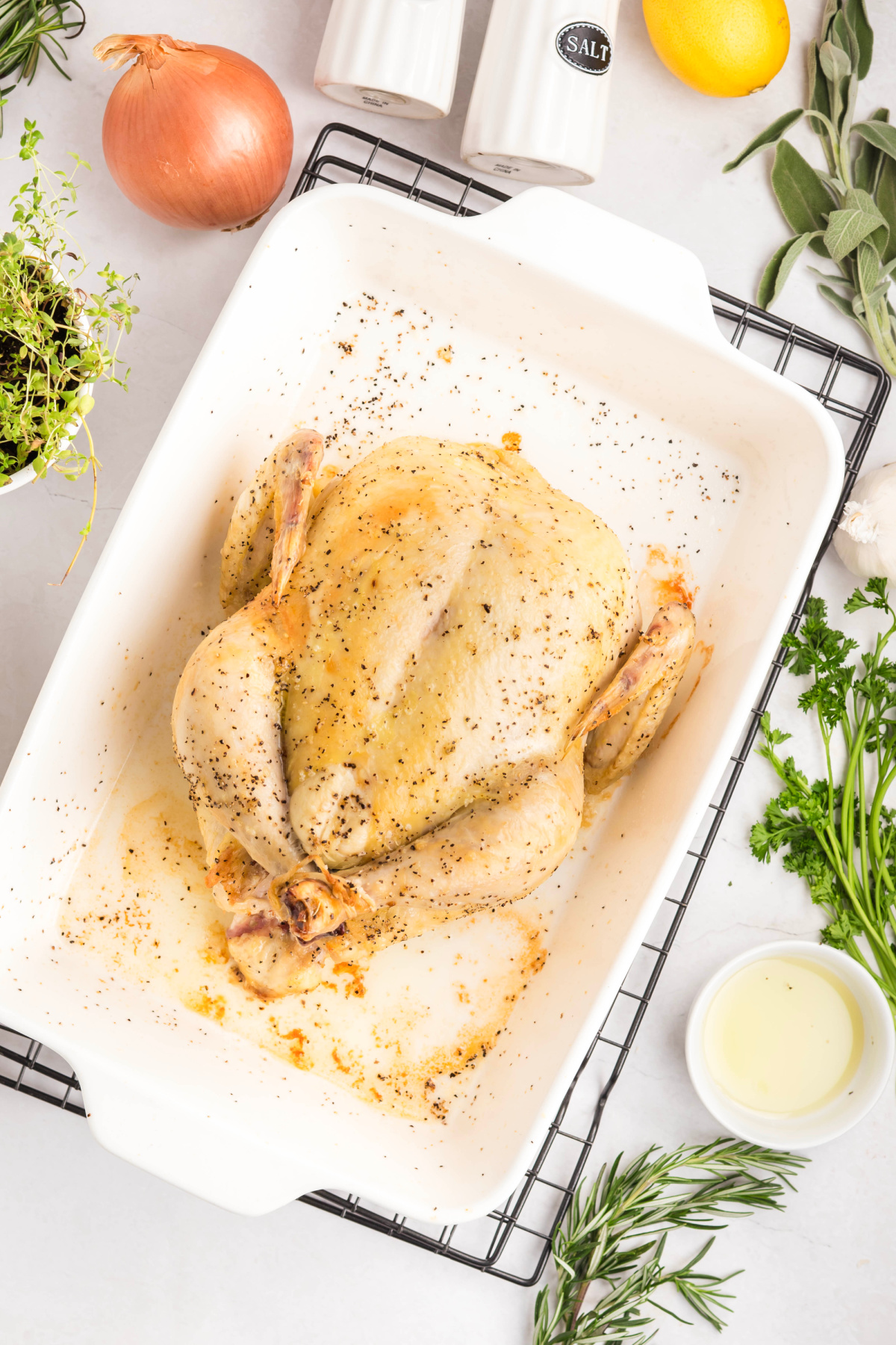 Whole chicken in a baking pan.