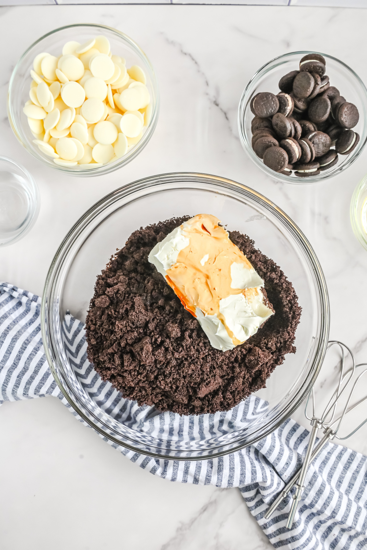 Cream cheese, crushed Oreos, and extracts in a large bowl.