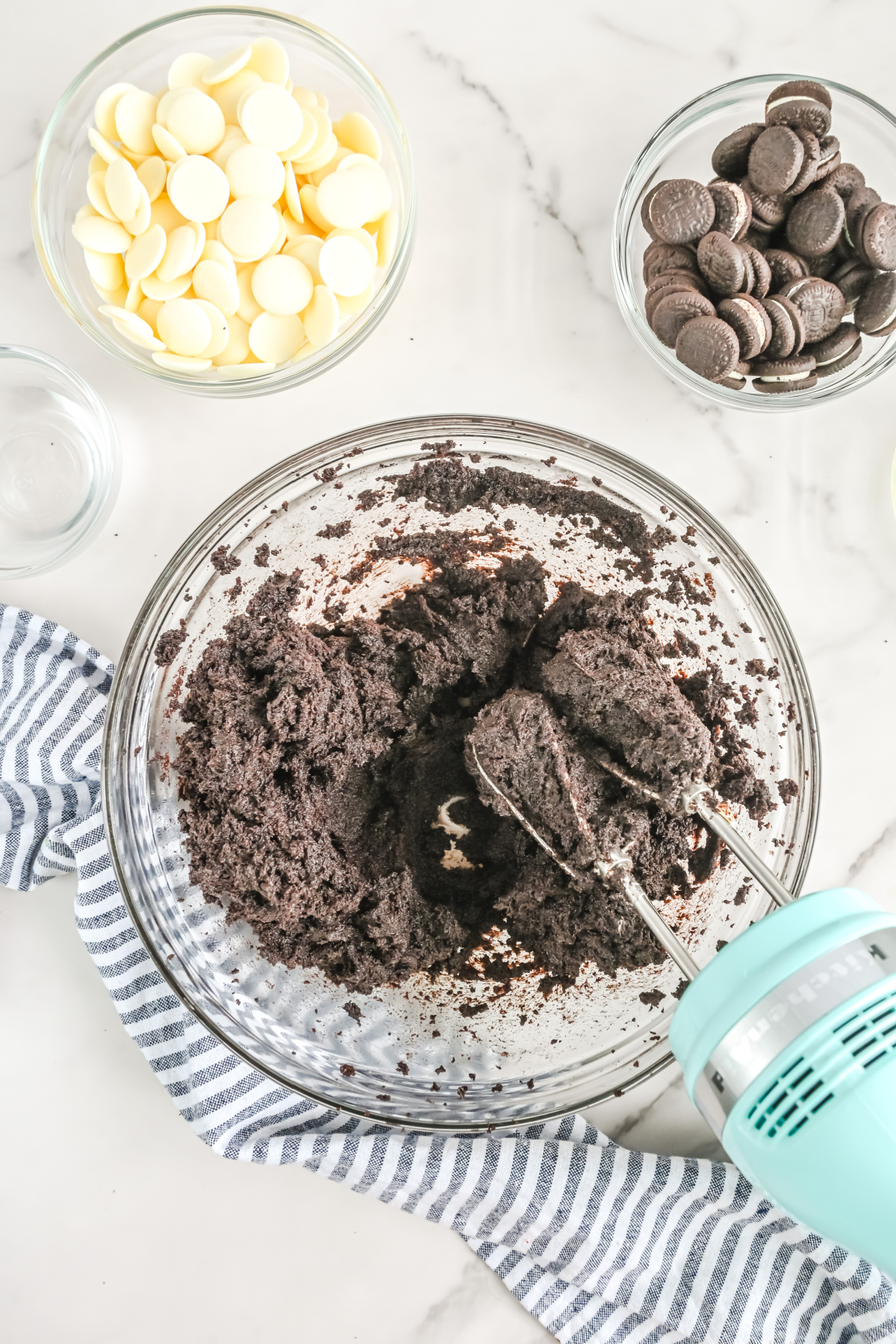 Cream cheese, crushed Oreos, and extracts combined with a mixer.