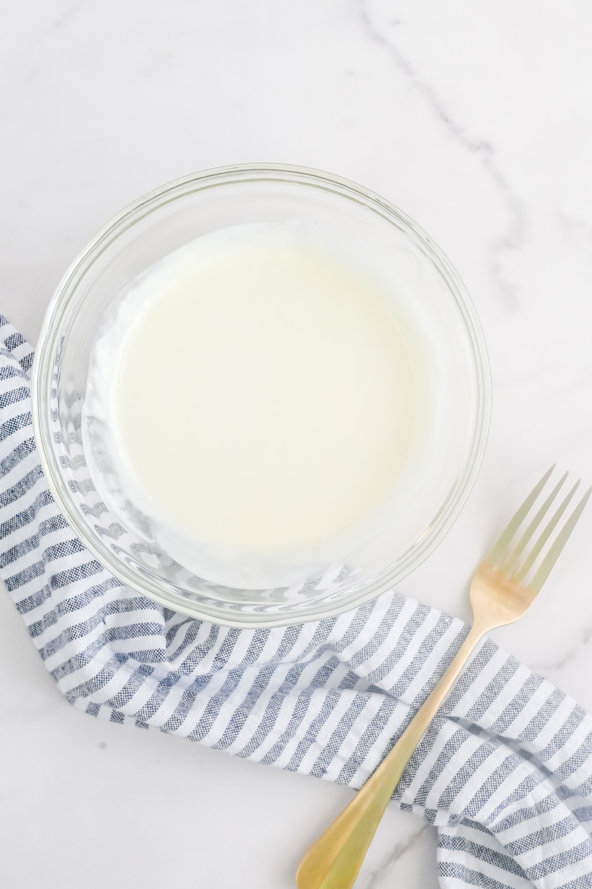 A bowl with melted white chocolate in it.