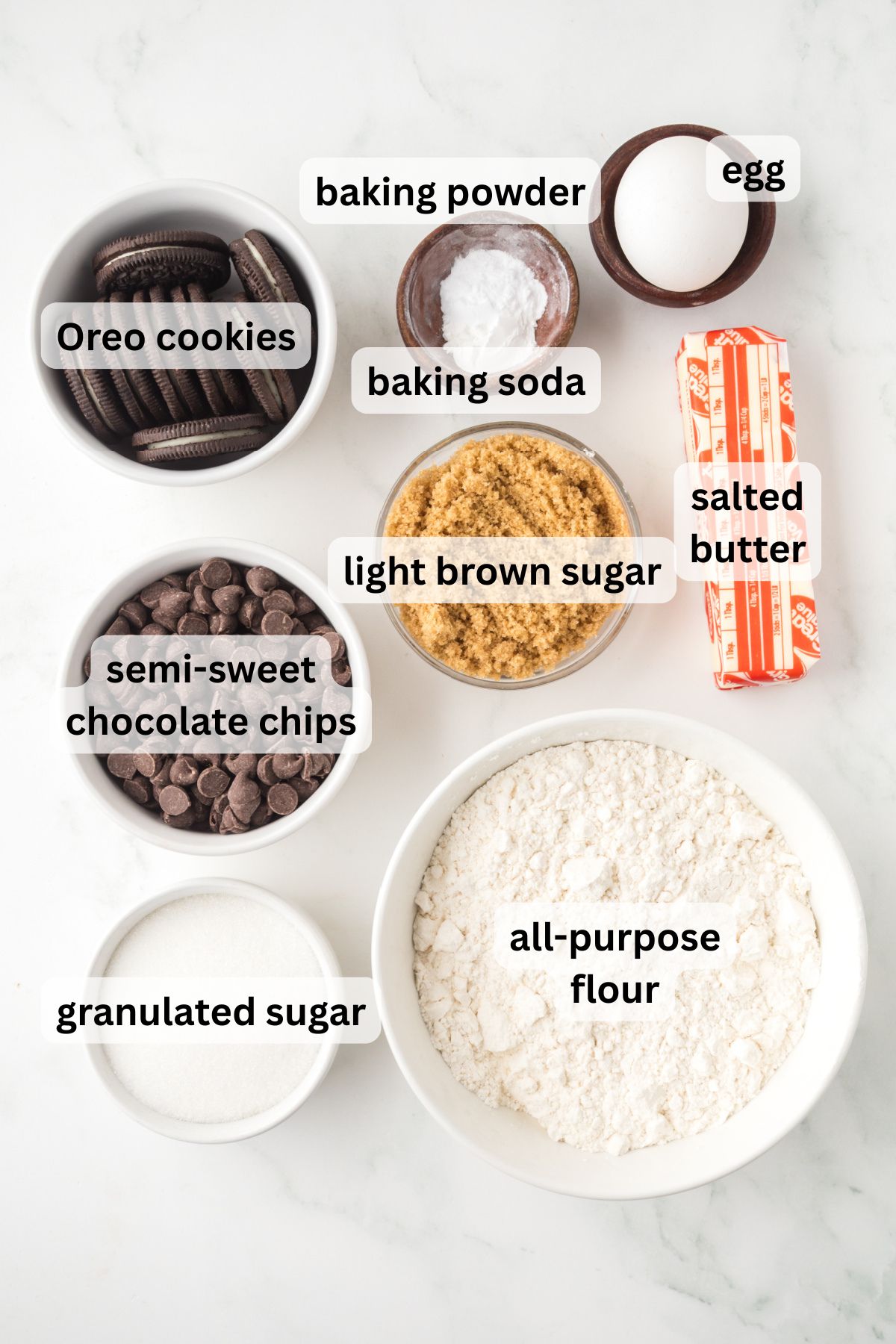 All of the ingredients needed to make Oreo stuffed cookies in bowls on a table.
