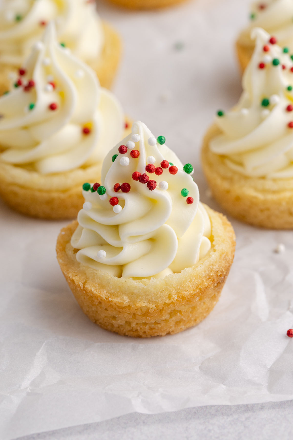 Sugar cookie cups with christmas sprinkles on top.