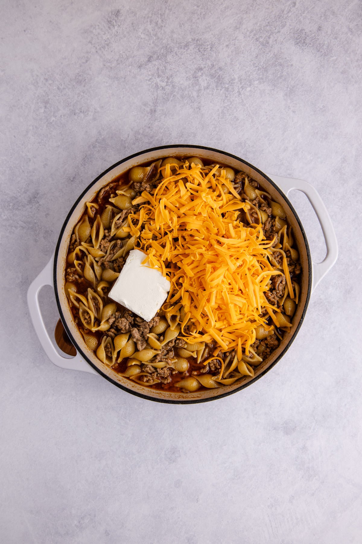 Cream cheese and shredded cheddar added to the pot.